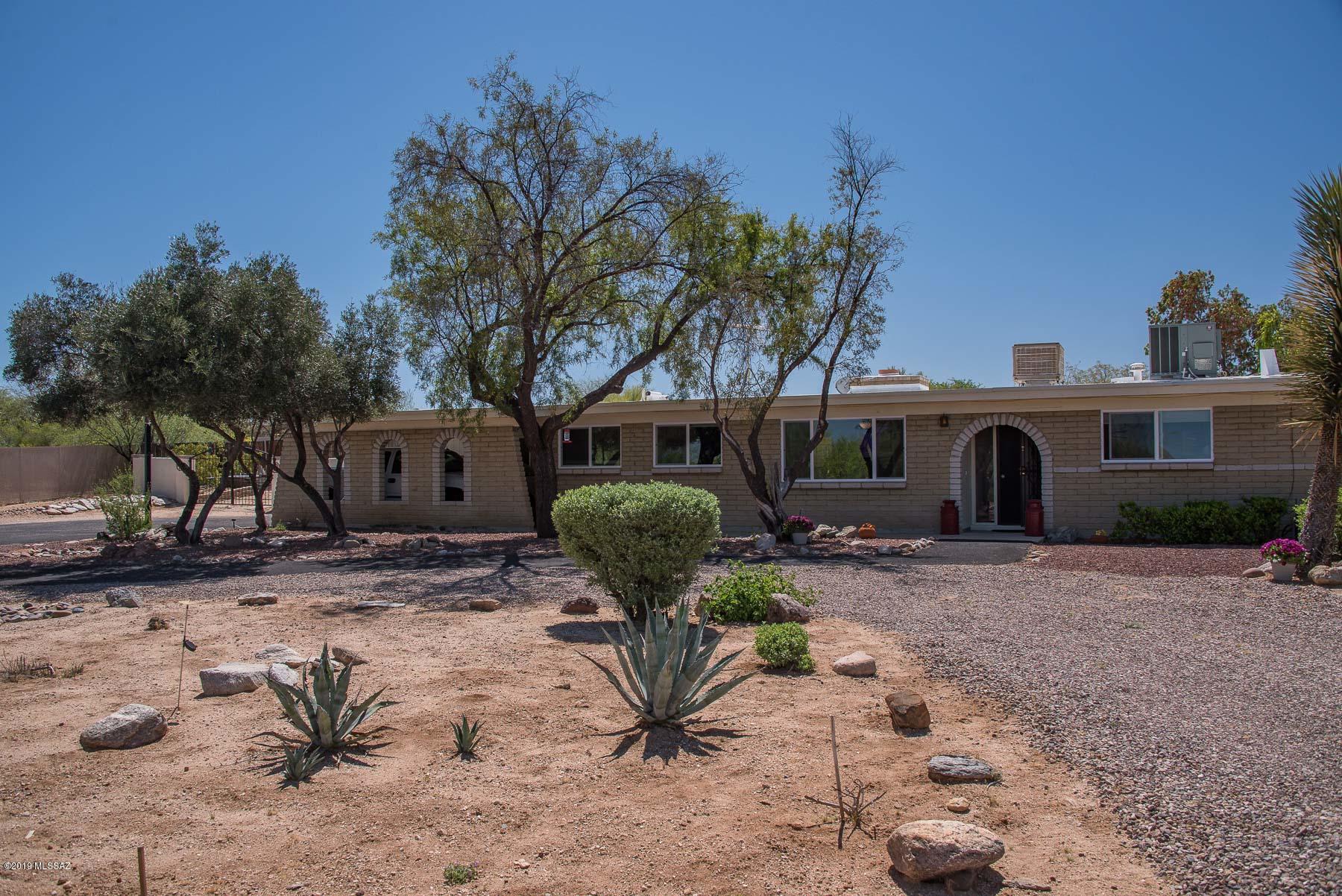 Excellent home on a large lot with mountain & sunset views, cool pool & ramada, covered RV parking, huge backyard with garden areas, pavers and more!  Backyard has lots of room for your enjoyment!  Front yard has beautiful curb appeal with circular driveway and carport.  House features large master bedroom with door right to backyard.  Kitchen has granite counters and lots of storage space.  Open living areas with welcoming dual sided fireplace.  And an excellent Arizona Room to hang out and entertain. AHG Home Warranty Guardian plus Pool.
