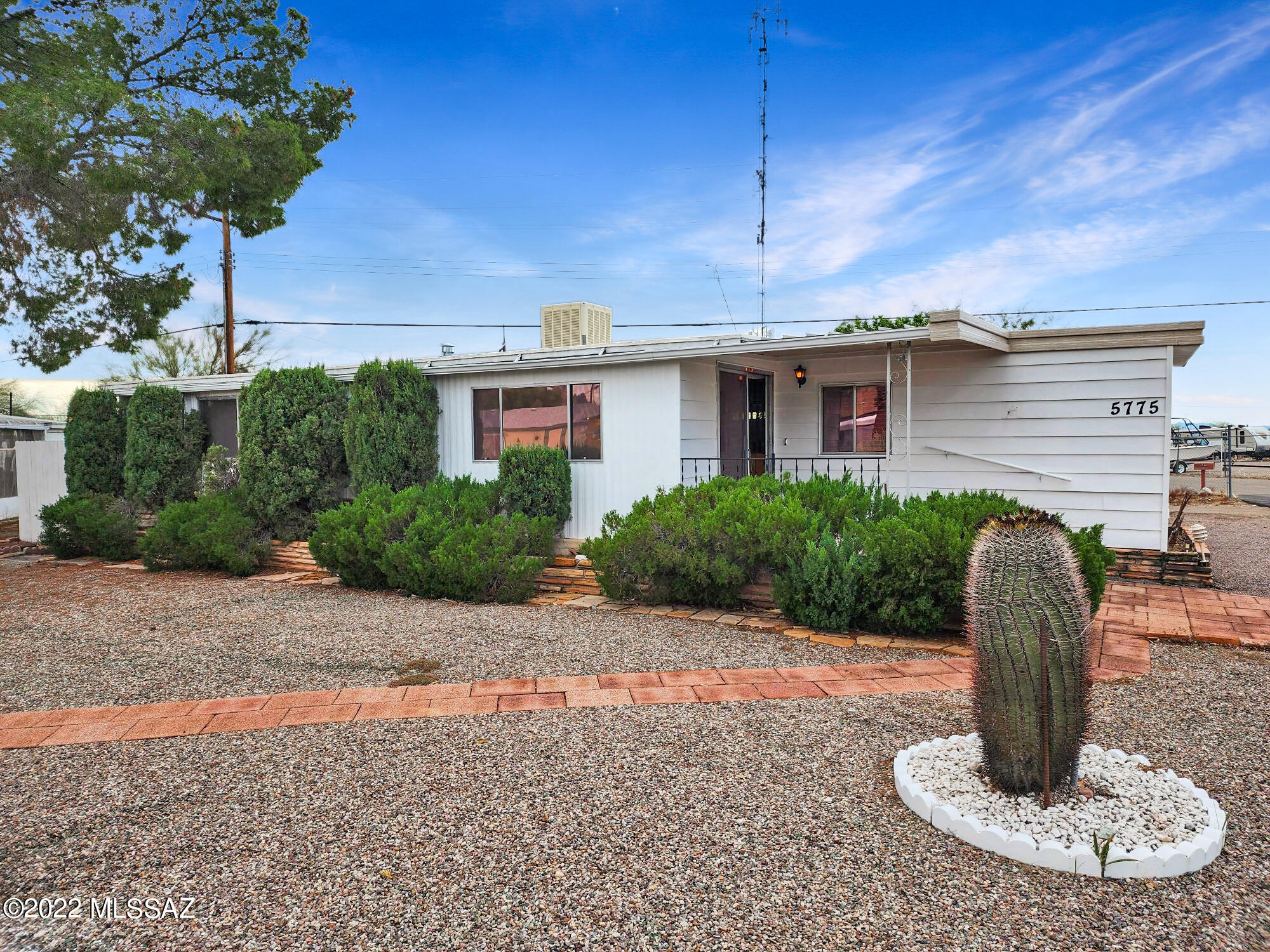 Check out this well cared for affixed mobile home with a large brick workshop with plenty of storage in the beautiful 55+ Tucson Estates! Living room in the front with kitchen and eating area in the middle. Laminate and carpet flooring throughout the home. Newer HVAC unit! Tandem covered carport on west side and covered patio entry on north. Private backyard for many activities. The HOA fee includes many community amenities! Come see today!