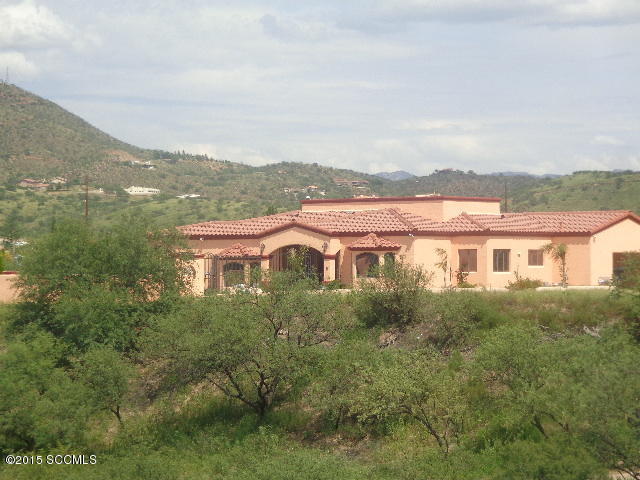 Beautiful home in Central Nogales with over 2700 sq. ft living space. This home has spacious bedrooms, custom kitchen with an island, large living room with vaulted ceiling and exposed beams, large laundry area,[] and tile surroundings in bathrooms. Enjoy city views and sunsets from it's large front area patio area.[] Very easy to show!