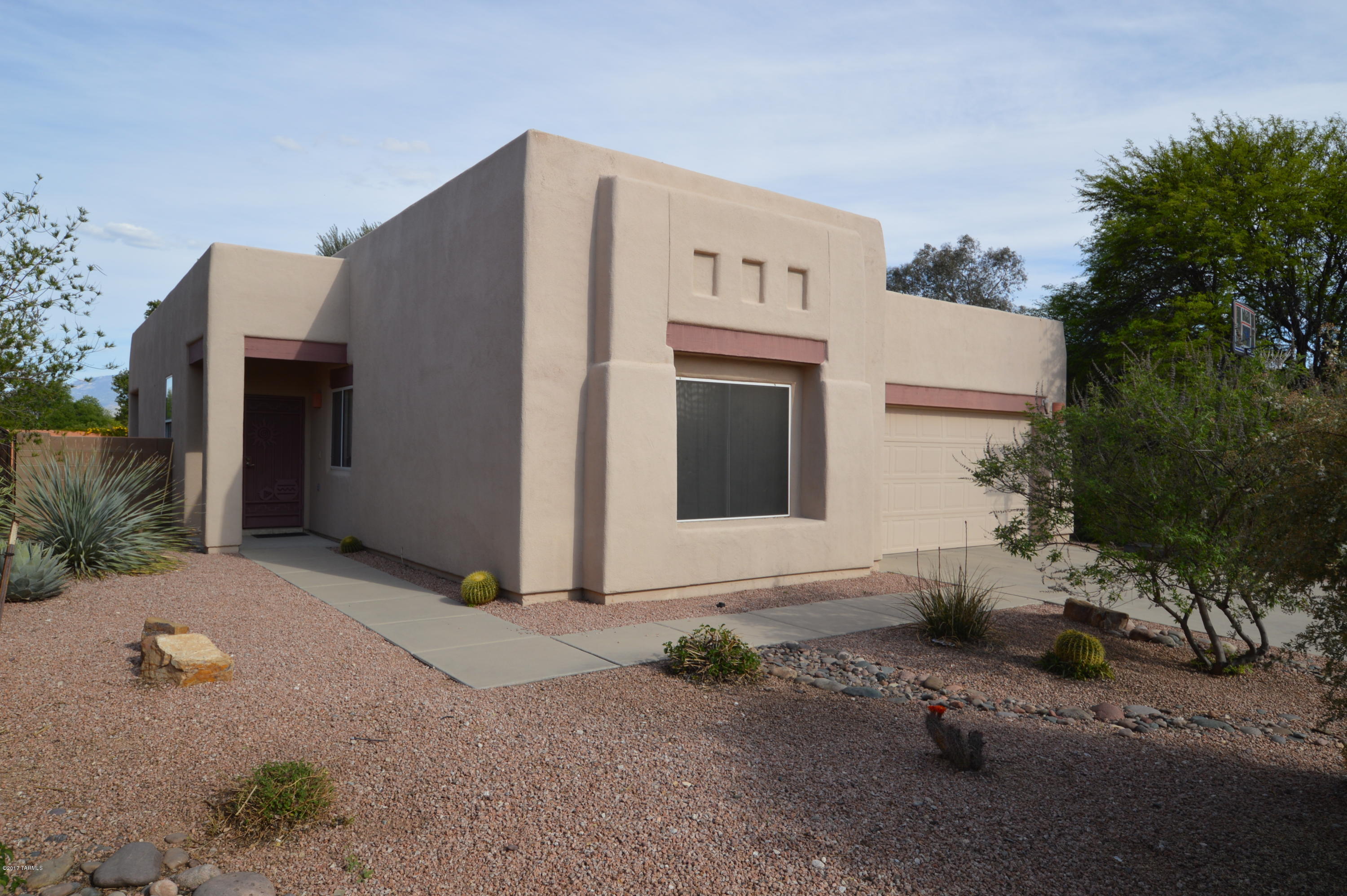 Popular AF Sterling Santa Fe model tucked away at the end of a cul-de-sac. Enjoy the advantage of a premium pool-sized yard with a view of the Catalina's and the Rincon's. Fenced pool yard with premium custom pool and water features. Its like living in a resort!  Newer paint, flooring and cabinetry throughout make this a dream to live in. Rounded-corner architecture, interior plant shelves, and two media centers give this contemporary southwest charmer a warm and modern feel. This diamond in the desert is just waiting for you...SO CALL NOW!!