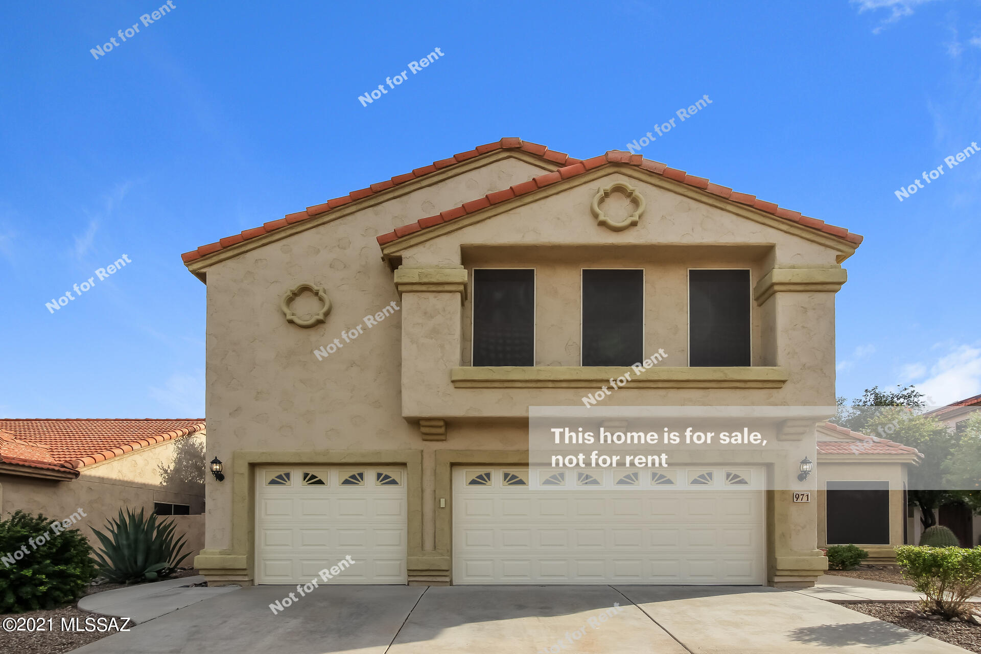 This Tucson two-story home offers an in-ground pool, a patio, quartz countertops, and a three-car garage.