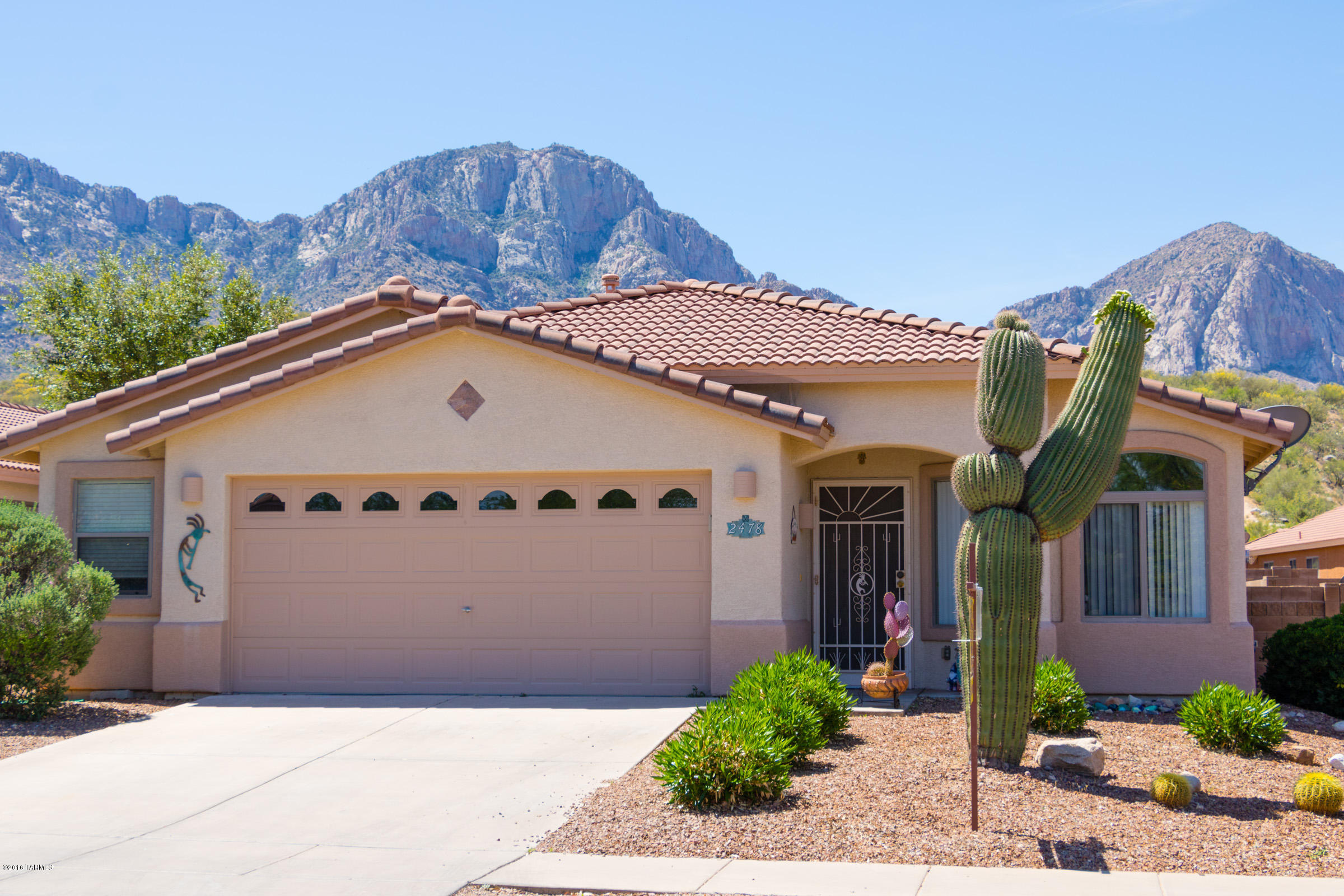 Wonderful home nestled at the base of the Catalinas. With 3 BR/2BA and a spacious, open floor plan, this home is perfect for entertaining family and friends. The interior of the home was painted in October, tile floor and interior of home have been professionally cleaned and is ready for you to move in! You can step outside the slider to a covered patio and amazing mountain views. The over-sized 2 car garage creates the space of almost 2 1/2 garages with plenty of built in storage. Home is close to shopping, dining, schools and Catalina State Park. A must see!