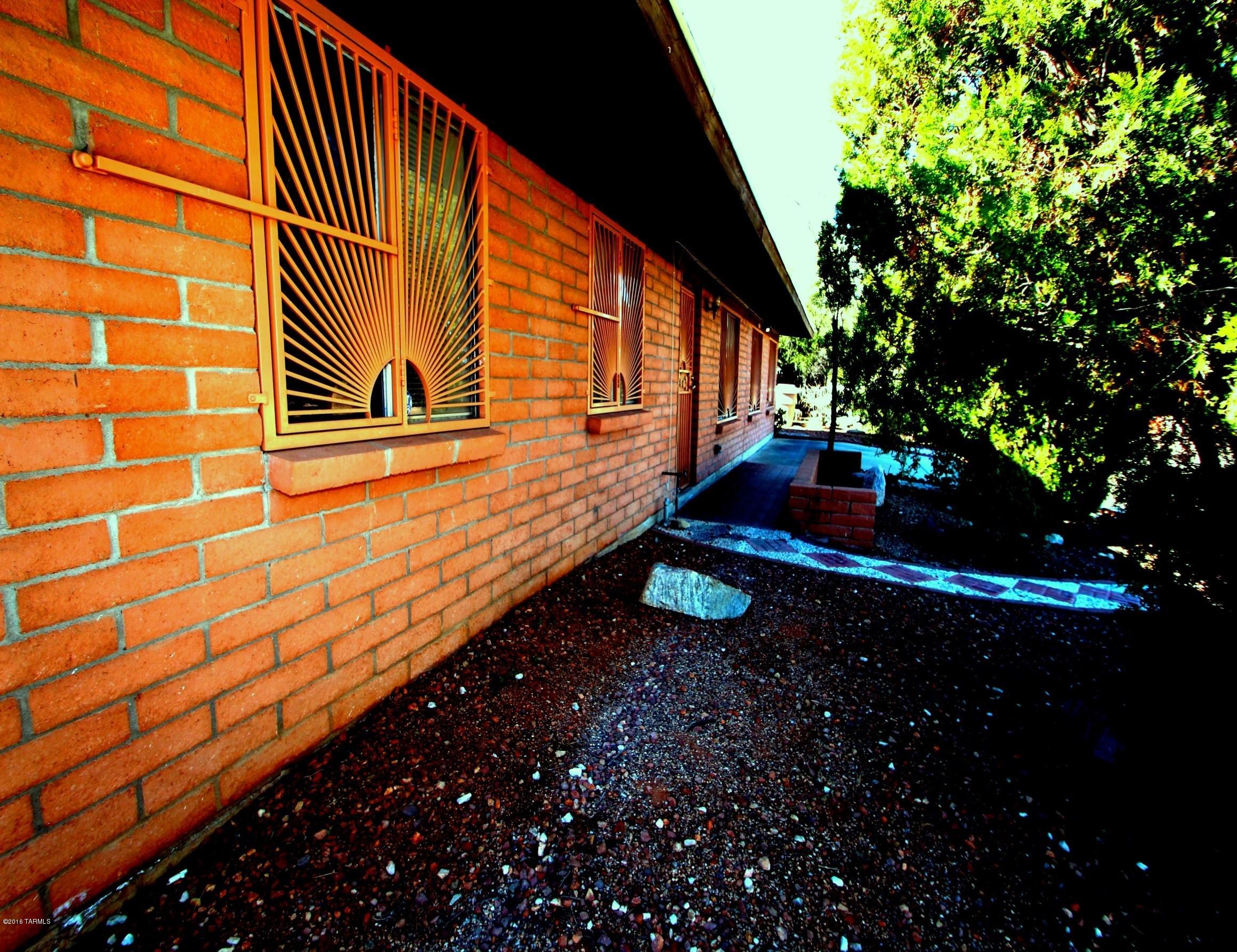 No A/C, Evap cooler only. Charming adobe brick home close to all amenities. Bright open floor plan invites you to this 4 BR plus den home with lots of windows. Master BR offers large linen closets and lots of privacy. Open kitchen with eat in area offers walnut cabinets and white appliances, SS sink and laminate counter tops. Enjoy the large Arizona Rm with brick flooring and picture windows with inside-outside feeling. All bedrooms offer light brown wood flooring with large closets and large windows. Low care large backyard with block fence offers lots of privacy and comfort such as above ground spa, small aviary, basketball hoop and views. Property is available to show by appointment with LA. See also MLS#21603099