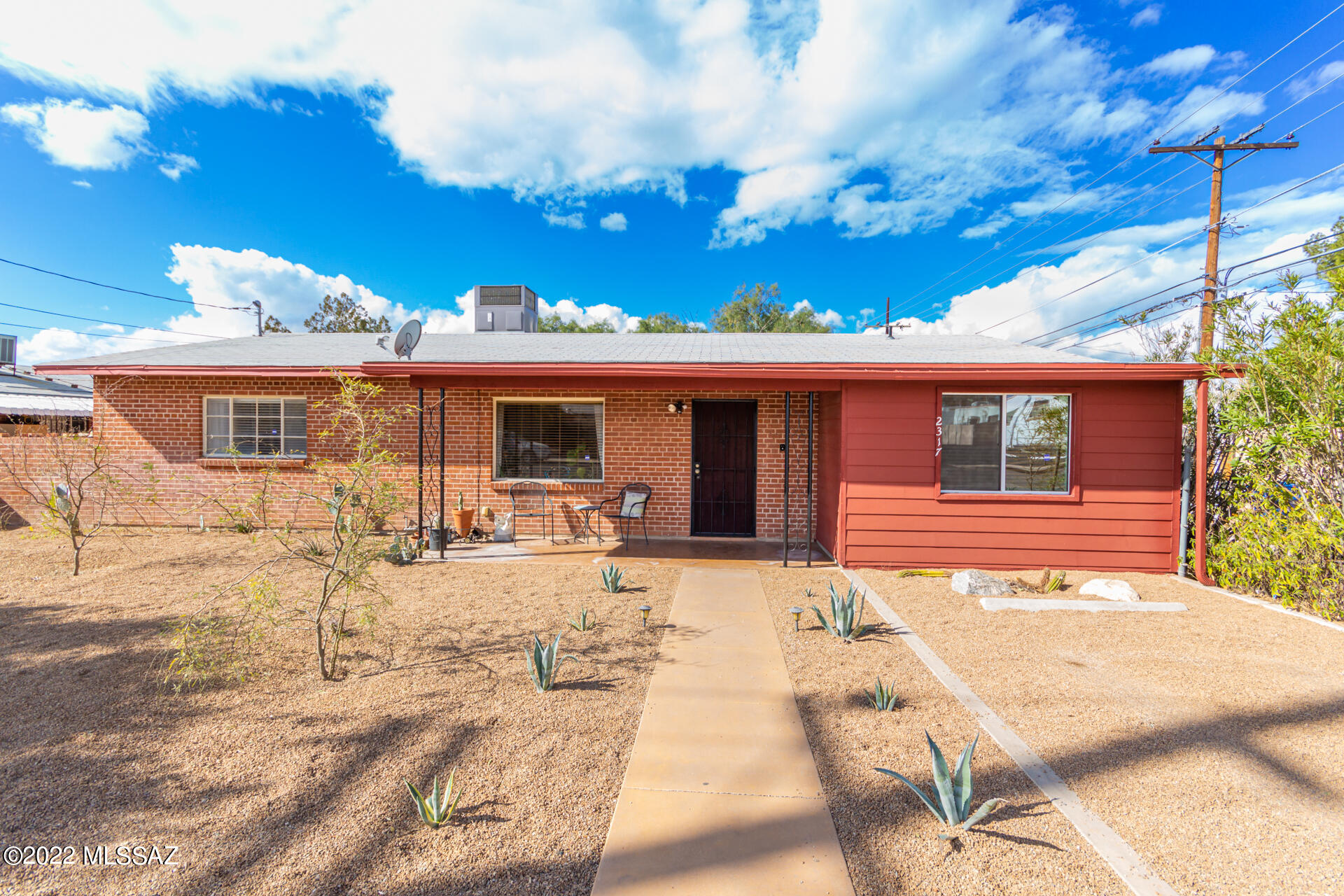 Look no further! This charming 4 bedroom, 2 bathroom - red brick home w/custom wrought iron front door & large front yard is the one you're looking for. Come inside the welcoming great room w/ neutral palette, Mexican tile flooring throughout, and abundant natural light. The eat-in kitchen offers ample white cabinets, granite counters, and a laundry closet. End your busy day in one of the spacious bedrooms with sizable closet. Host fun gatherings in this spacious backyard boasting a custom-covered patio, storage shed, and an RV gate. This property is conveniently located near shopping, restaurants, entertainment, hiking, biking and the University of Arizona! What are you waiting for? Call now!