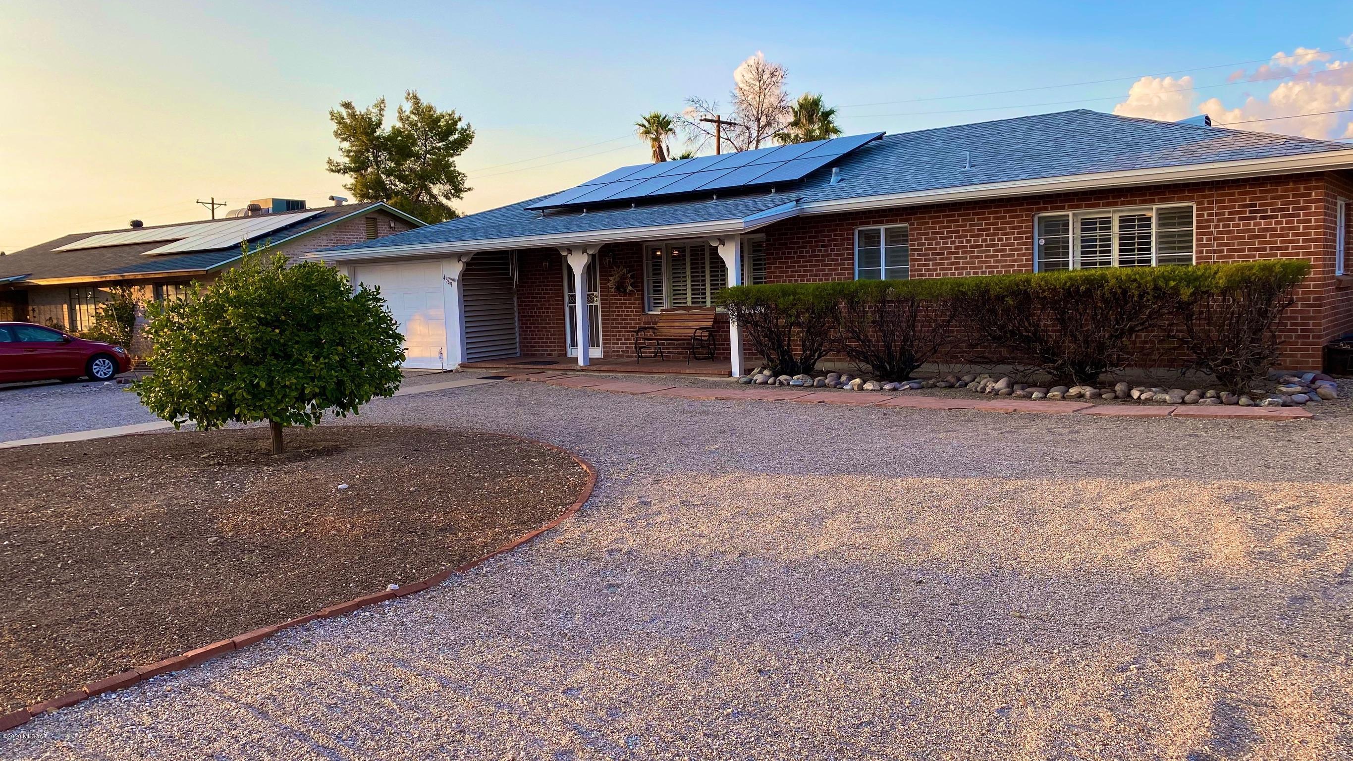 Beautiful and well maintained home in quiet central Tucson community. Double brick construction. Generous back yard, low maintenance landscaping with new irrigation system. Solar panel system - fully owned and covers 100% of electricity usage - conveys with home. Bonus storage off laundry room.  Carport mostly converted to a garage (not 100% enclosed) and has electric door opener. Half a mile from Reid Park and about 12 minutes to downtown Tucson/UA!
