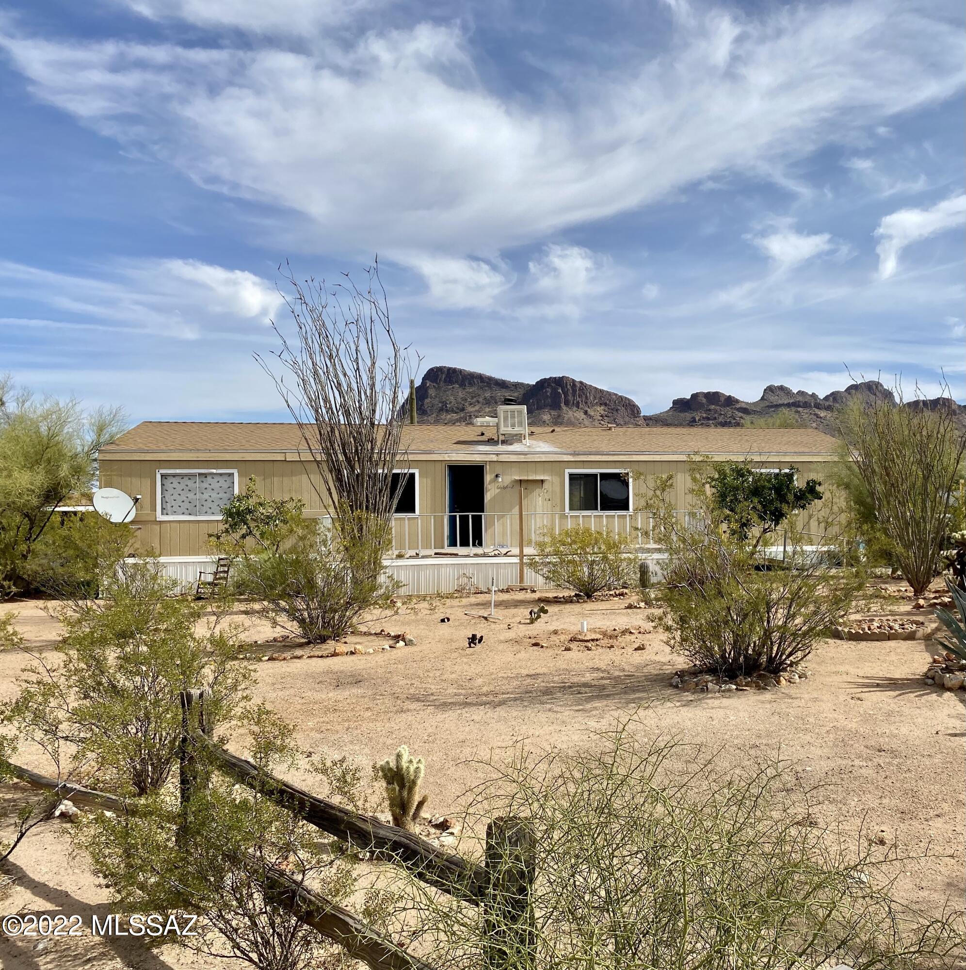 This 3 bedroom 2 bath home sits on a large lot with incredible mountain views. This home is close to the Saguaro National Monument. Several site built homes surround this lot. This lot currently has 2 separate electrical meters. The home is a ''fix -up''