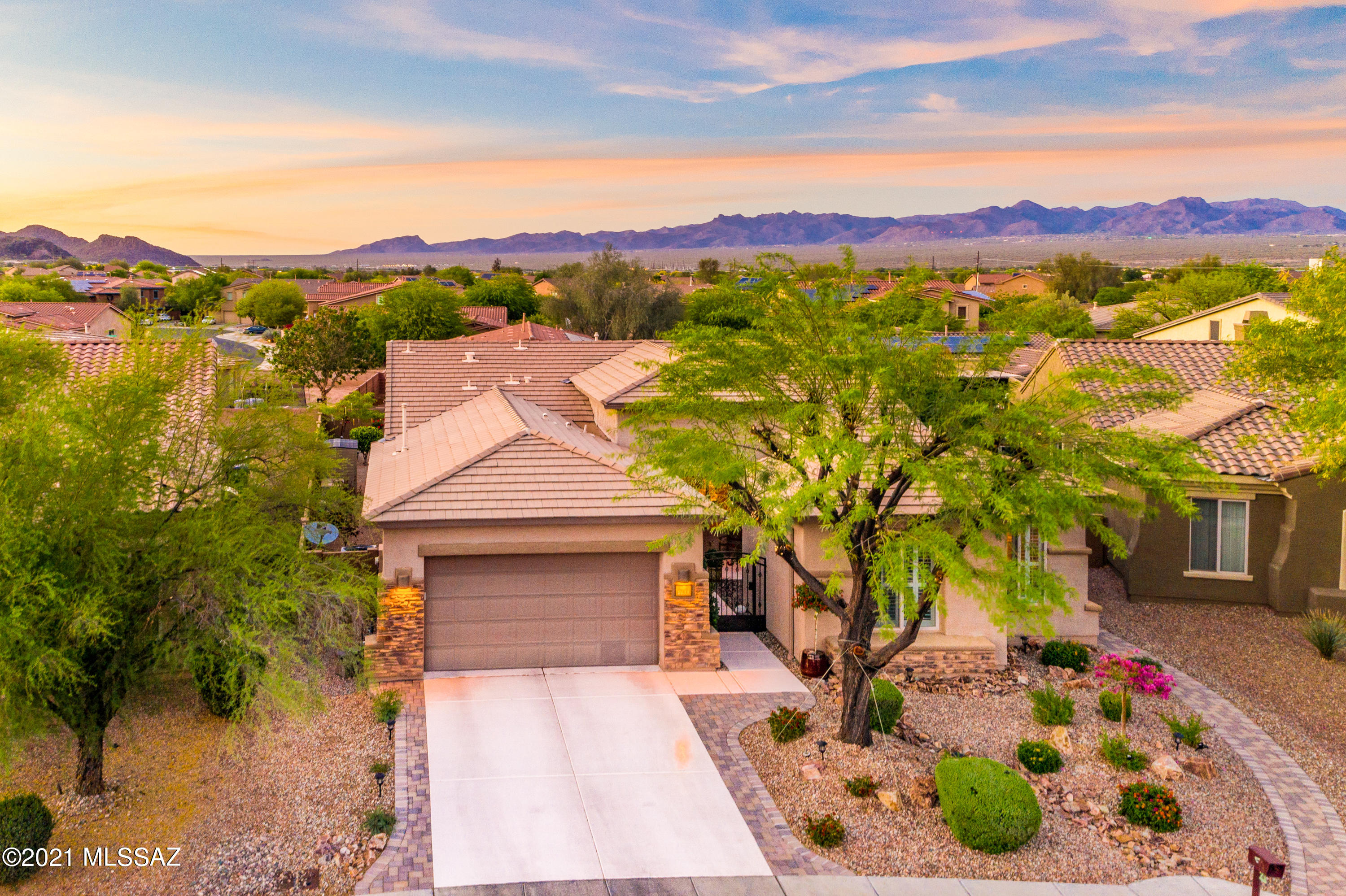 Seller will accept or counter offers in a range between $424,997 to $445,000. This gorgeous single-level home is welcoming as you enter the courtyard lined with flowers and a calming water feature. The spacious open floor plan boasts a modern kitchen with granite countertops and plenty of beautiful cherry cabinetry. It is encompassed by a great room with a cozy beehive fireplace and a formal dinning room that opens to a private patio. The Trumpet floor plan is unique and provides a plenitude of privacy. The master suite includes a large updated bathroom and ample walk-in Closet. As you step into the back yard you will be surrounded by an array of colorful flowers and plants, the serene sound of yet another waterfall...all while watching the amazing sunsets next to Sombero Peak.