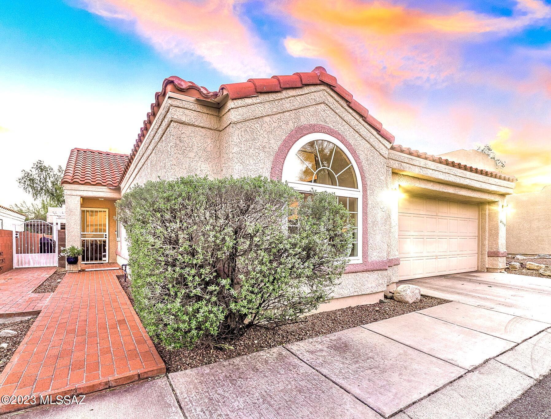 Rare opening in lovely Pima Hollow Community. Upgraded & open 3 bed 2 bath in convenient foothills local. Soaring ceilings, abundant dual-paned windows, new lighting and fans, accent alcoves. Luxe designer finishes include neutral tile throughout, granite tops, custom paint. Backyard oasis w/ attached bbq, ample counter space/bar with slate tops, ramada, soothing fountain, bench & mature citrus. Versatile front bedroom w/ closet, built-ins and double doors.  Roomy kitchen w/ breakfast nook boasts quartz tops, s/s appliances and pantry. Primary suite has huge closet, private access to yard, travertine surround in shower with Jacuzzi tub. Oversized 3rd bedroom w/ cozy window nook next to 2nd bath with stone surround. Ample storage in garage. Quiet community, neighborhood pool. Welcome Home!