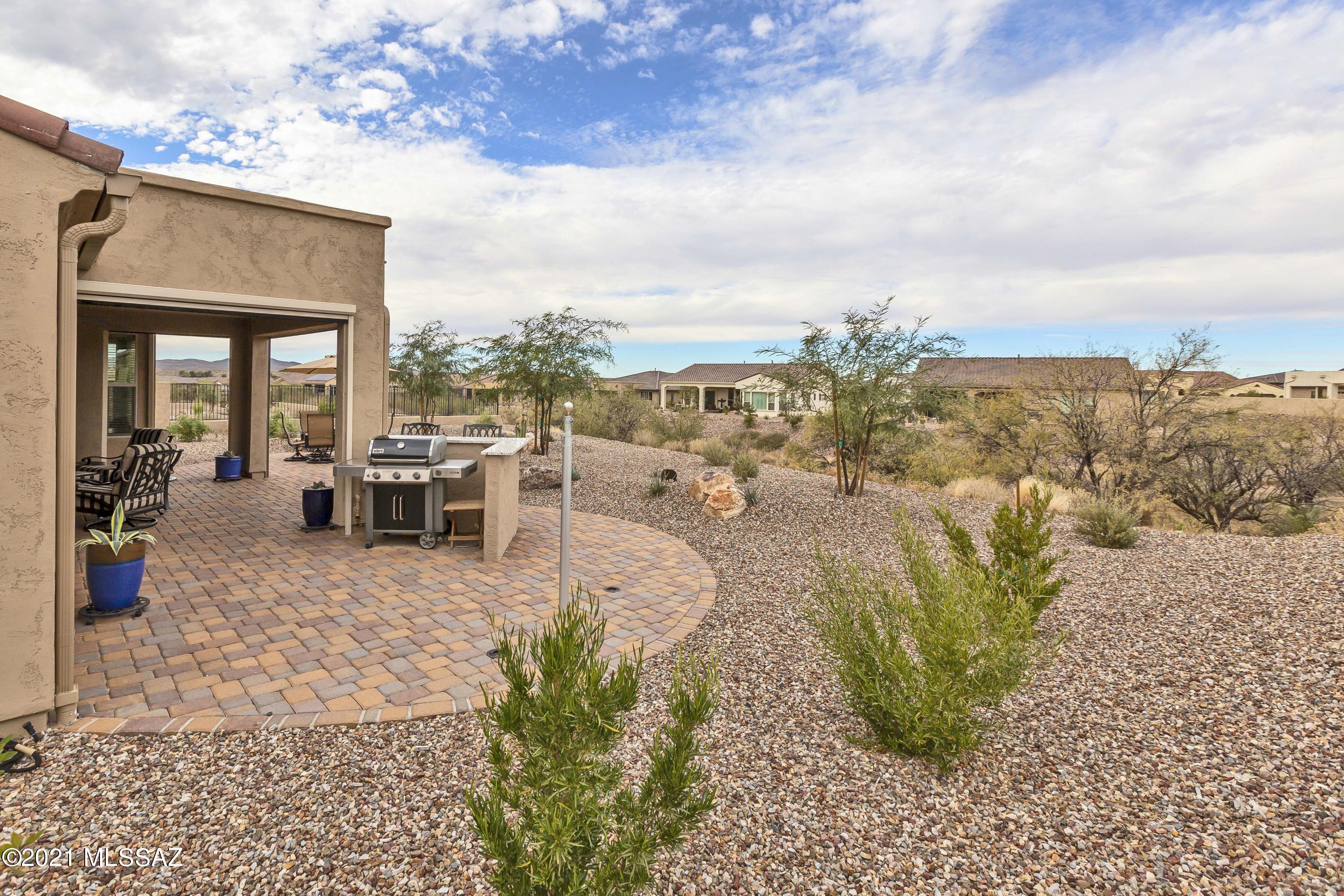 This Pavona is two years new! Why wait to build new when you can buy this exceptional home now. The home features high end finishes throughout and lots of storage. This Pavona model has a Den/Craft Room that has French doors that open to your front porch, from here enjoy a morning cup of coffee as you gaze at the beautiful Catalina mountains. Features include expanded master bedroom, w/walk-in closet, extended garage, plank tile floors in all the right rooms, walk-in pantry, high end cabinets, high end quartz counter tops, upgraded ss appliances, and more! Enjoy SaddleBrooke Ranch Amenities then come back and watch the sunset from your back patio, that is situated to the open common area.