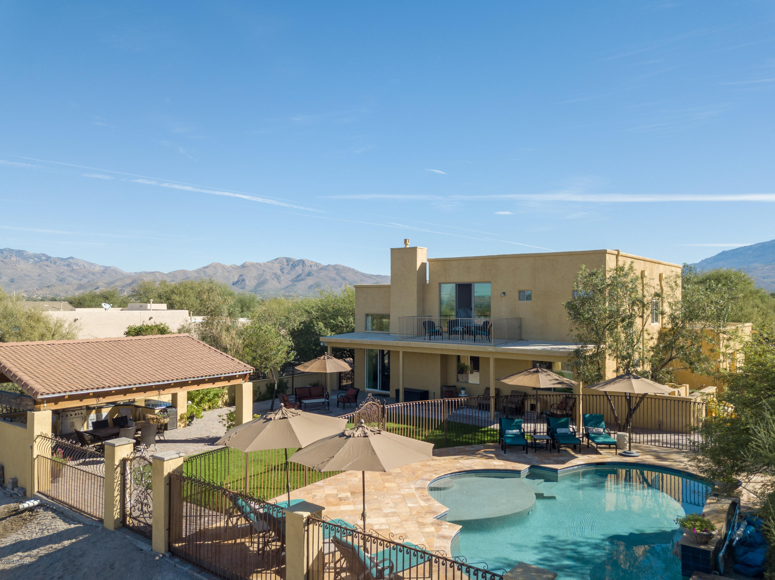 Welcome to your new home in the beautiful gated community of Arizona Estates! HOMES IN THIS SUBDIVISION ARE RARELY AVAILABLE!  This prime eastside subdivision was built by Pepperviner & is unlike any other home in the neighborhood. This property features an estate like feel with sweeping 360 degree mountain views. The sparkling pool is like new, installed in 2016, and features smart technology and solar heat (owned). Enjoy Tucson year round living at its finest with custom built stucco & tile ramada featuring an outdoor kitchen, granite countertops, concrete benches & built in BBQ. The interior of the home boasts 5 bedrooms & 3 bathrooms, 2 offices, fresh interior paint, and wood laminate & tile throughout. The open kitchen has vaulted ceilings, expansive kitchen island and granite countertops! The master bedroom features a separate sitting room as well as an en-suite with dual vanities, shower, garden tub and walk-in closet! The entire property is fenced with stucco wall & hand forged iron accents & gates.  Make your appointment today, WILL NOT LAST!