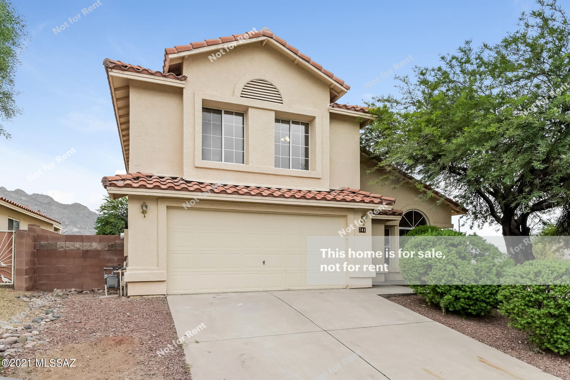 This Tucson two-story home offers an in-ground pool, granite countertops, and a two-car garage.