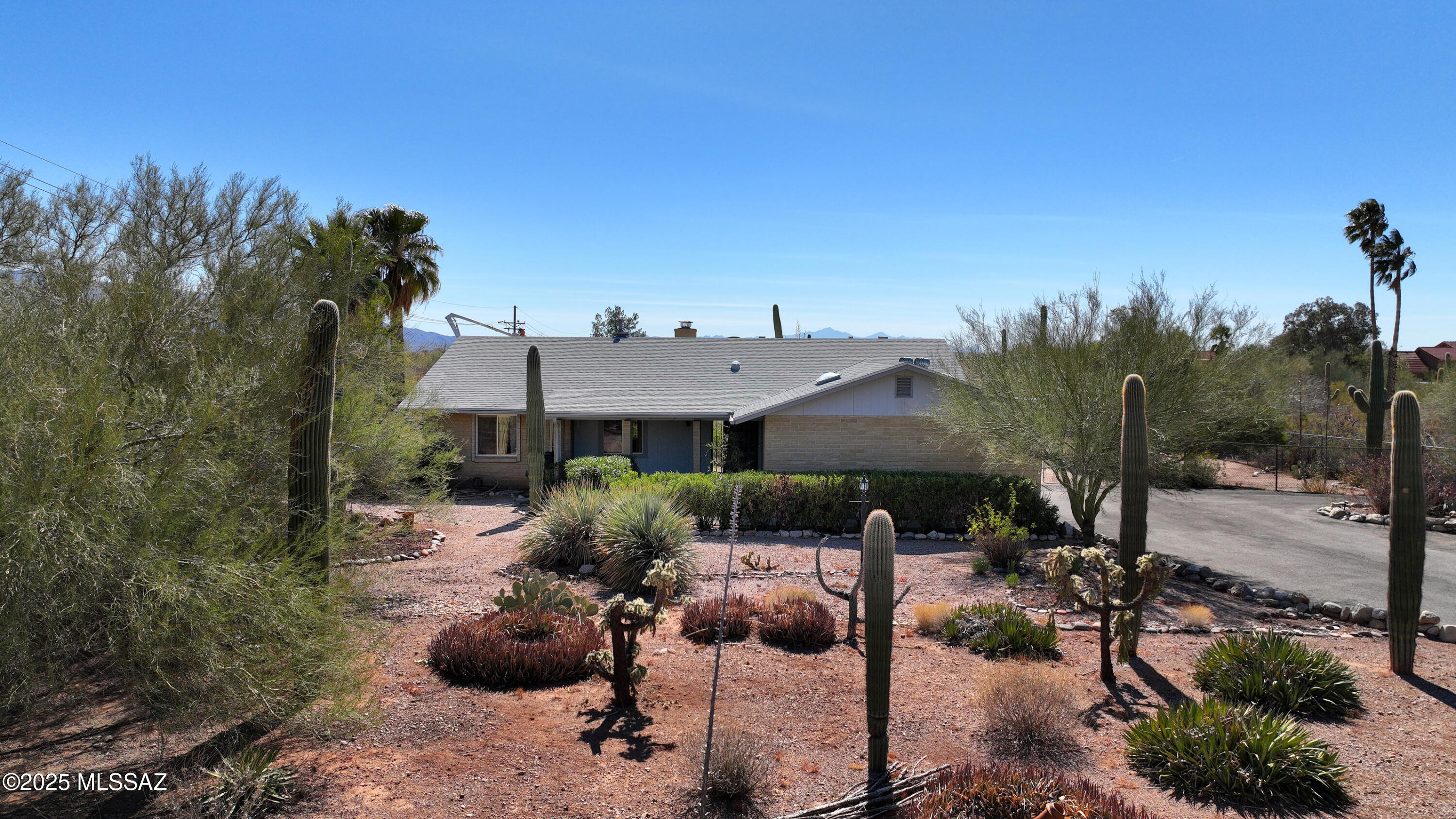 Exciting opportunity for 4-horse zoning, swimming pool, desert landscape with majestic saguaro cacti & a fully fenced, cleared rear yard encompassing 2 horse ramadas, water stations & 20-ft pole lights.  Room for RV storage too! Front views of the Catalina Mtns & rear views of Agua Caliente Hills, Rincon & Santa Rita Mtns are visible from nearly every room. Family Rm features clerestory skylights & beehive gas fireplace & opens to an Arizona Rm with tile flooring & sliders to covered patio.  Private primary suite also opens to the back patio & pool & the entire home showcases neutral décor with fresh paint & new carpet thruout. The pool area is nicely landscaped & enclosed with a block wall perimeter that also conceals a separate spacious courtyard with gas/electric hookups. Other records for this estate sale support the following replacements:  water heater (2023), Trane gas furnace and condenser with Smart Control (2020) and roof (2021).