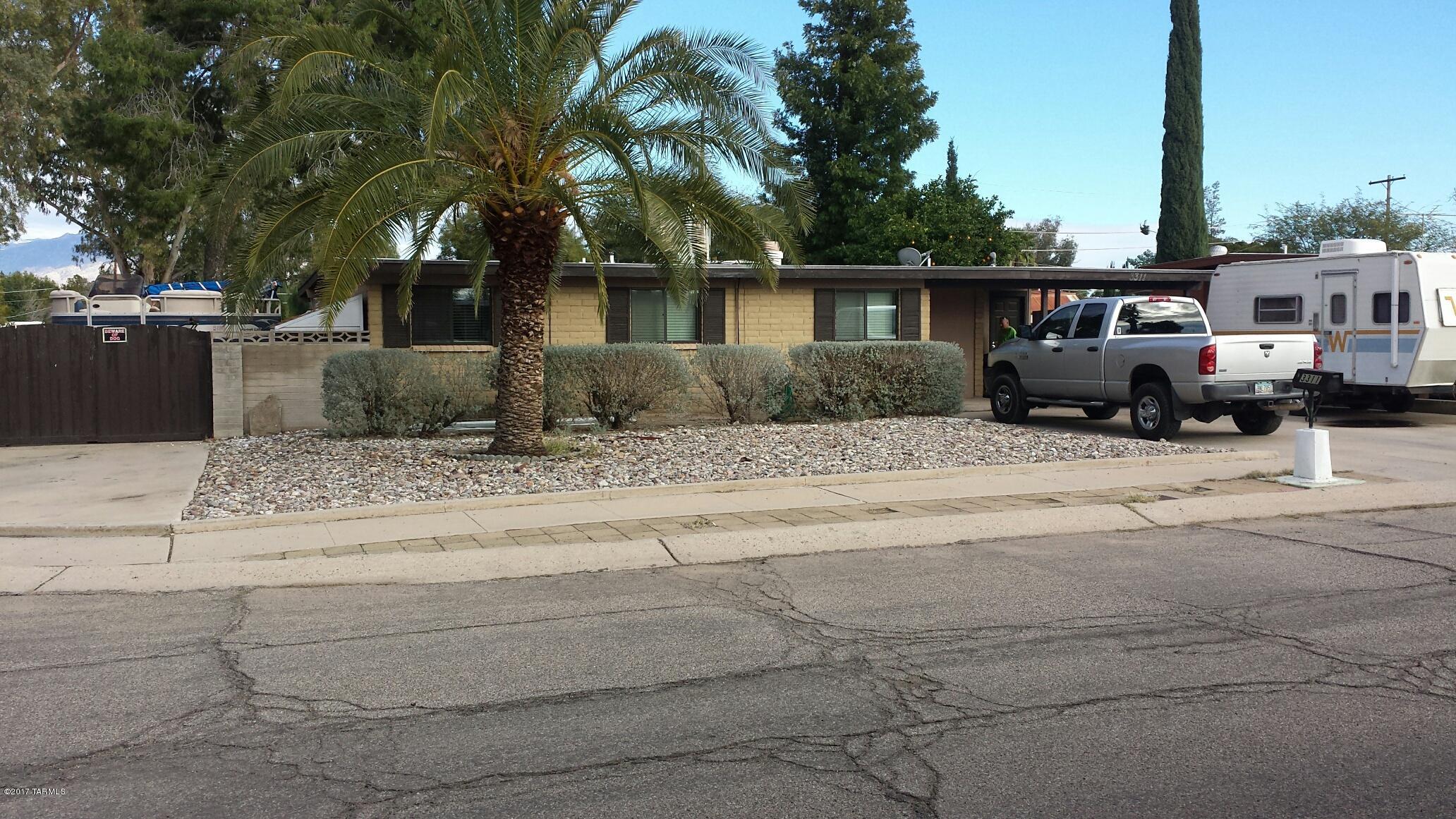 Come See this Beautifully remodeled Home. Kitchen includes Alder Cabinets, S/S Appliances, upgraded lighting and soap stone covered Island. Both bathrooms have been updated including ceramic tile shower surround. This home is also equipped w/ Dual cooling. The Backyard boasts mature fruit bearing trees and a renovated pool that has been re plastered, new equipment, new tile and extended cool decking & l.E.D. lighting and a diving board w/ waterfall feature. All of this on a corner lot w/parking for six vehicles & RV Space.