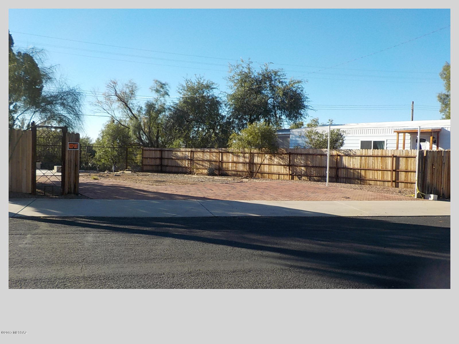 55+ community with an 18 hole golf course,tennis,pickle ball, pools,activity center plus so much more. Fenced lot!!! Some pavers already there. Wonderful views of mountains. Close to hiking trails in Tucson Mtn. 
Taxes reflect both land and home before home was removed.