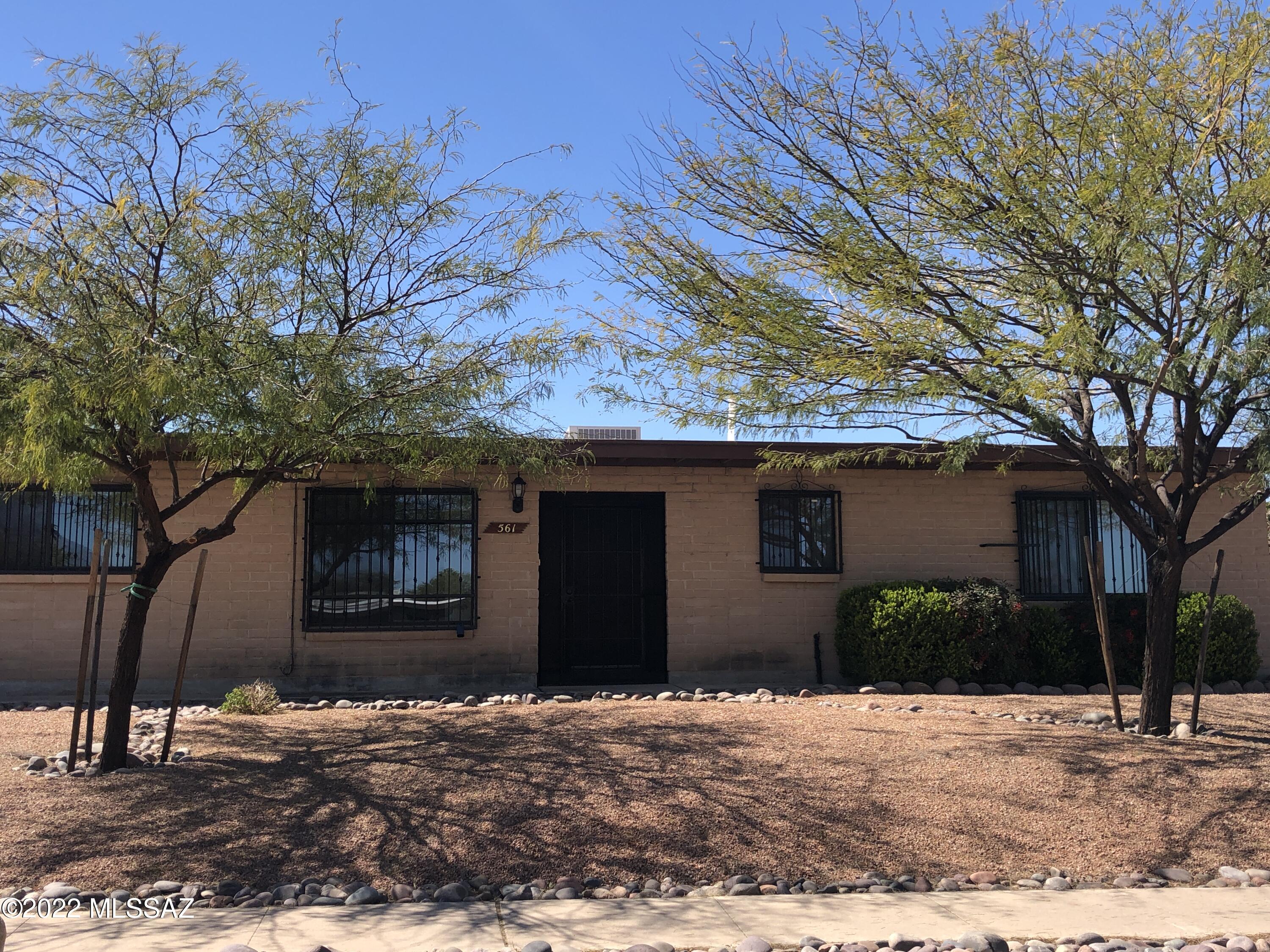 NO HOA!  East side 4/2 home on .25 acres with POOL!  Come see this well maintained, original owner home featuring dual pane windows and  gorgeous wood plank ceramic tile throughout!  Kitchen has maple cabinets, Corian countertops, SS refrig. and range, dishwasher, disposal, lazy Susan and pantry.  Enjoy the best of AZ outdoor living in the spacious backyard featuring POOL, large covered patio, shed, block wall and double gate access to the alley.  Security bars on windows as well as screened security doors.  Washer and dryer included!  Extra concrete slab/driveway next to the carport for boats/RV/trailer, etc!  Great east side location near schools, shopping and restaurants!