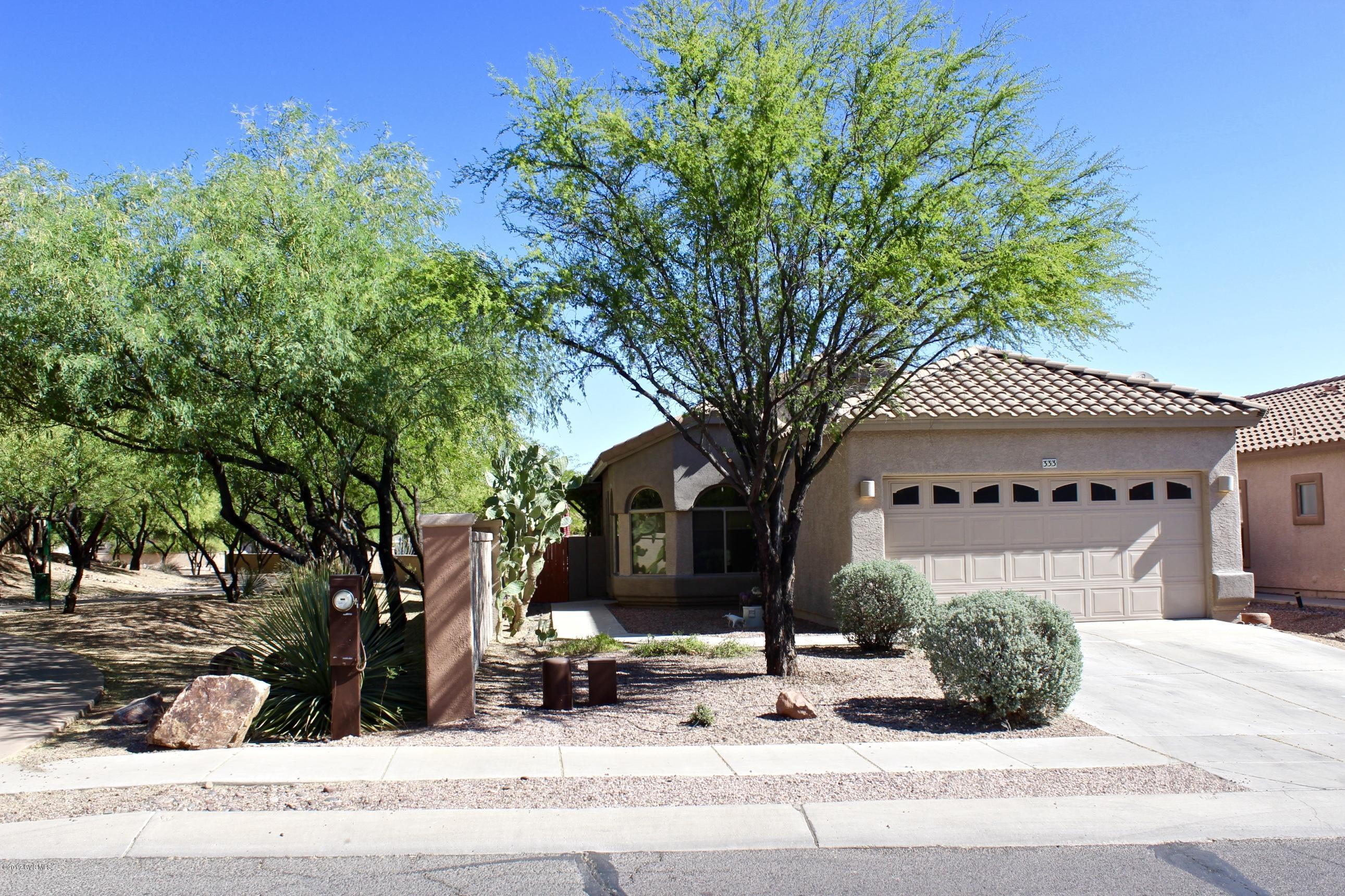 Rancho Sahuarita gives you the opportunity to be a part of a great community & join in on events to make your lifestyle fun. Living here, you'll cherish all the wonderful amenities available! Enjoy a bird's eye view of the lake from the dining area! The kitchen offers a center island cart for extra counter space & storage, pull out shelves in cabinets, & an electric range w/ option for gas. Master suite has a spacious closet, & a walk in shower. The guest bathroom has an updated tiled shower and a whirlpool jetted tub. Savor every AZ evening out under the covered ramada patio! Peacefully settled next to the arroyo wash for extra privacy and space. Fresh interior paint, new carpet in one bedroom, cabinets in the garage, water softener, plus the floors have been professionally cleaned.