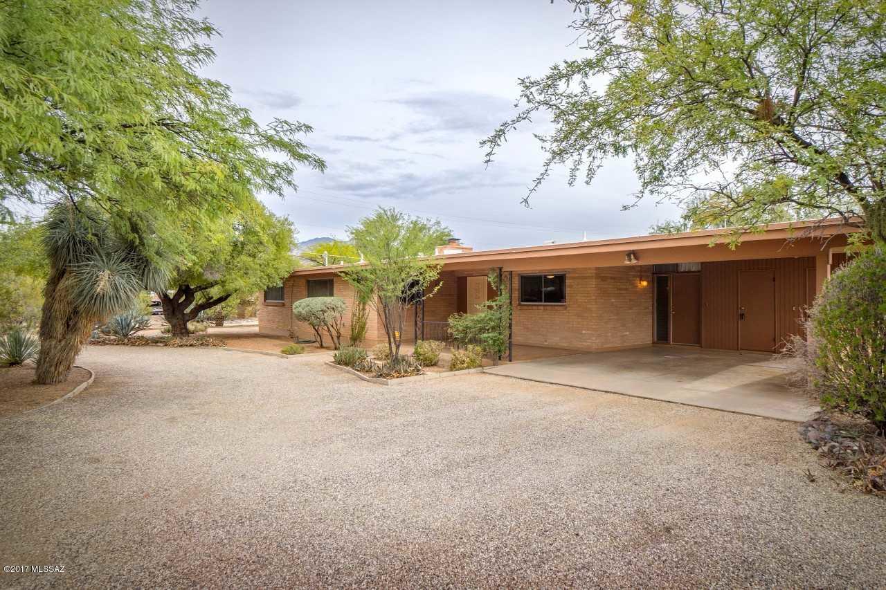 Appealing 3BR/2BA brick home in sought after Richland Heights neighborhood near Campbell/Ft Lowell.  This home has great bones and has been lovingly maintained both inside and out. Great curb appeal and a covered front patio welcomes your guests. Brick wood-burning fireplace in Living Room; Dining Room off kitchen; Master Bedroom offers walk-in closet with built-ins + updated vanity in MBA; 5-ceiling fans; lots of closet space and storage throughout.  ''Office'' off one bedroom has its own wall AC. Large walled rear yard boasts covered patio, mature vegetation, Mountain View and room for a pool. This home is special – don’t miss it! Add your own touches and make it a showplace. Convenient to bus line, restaurants, urban streetcar.