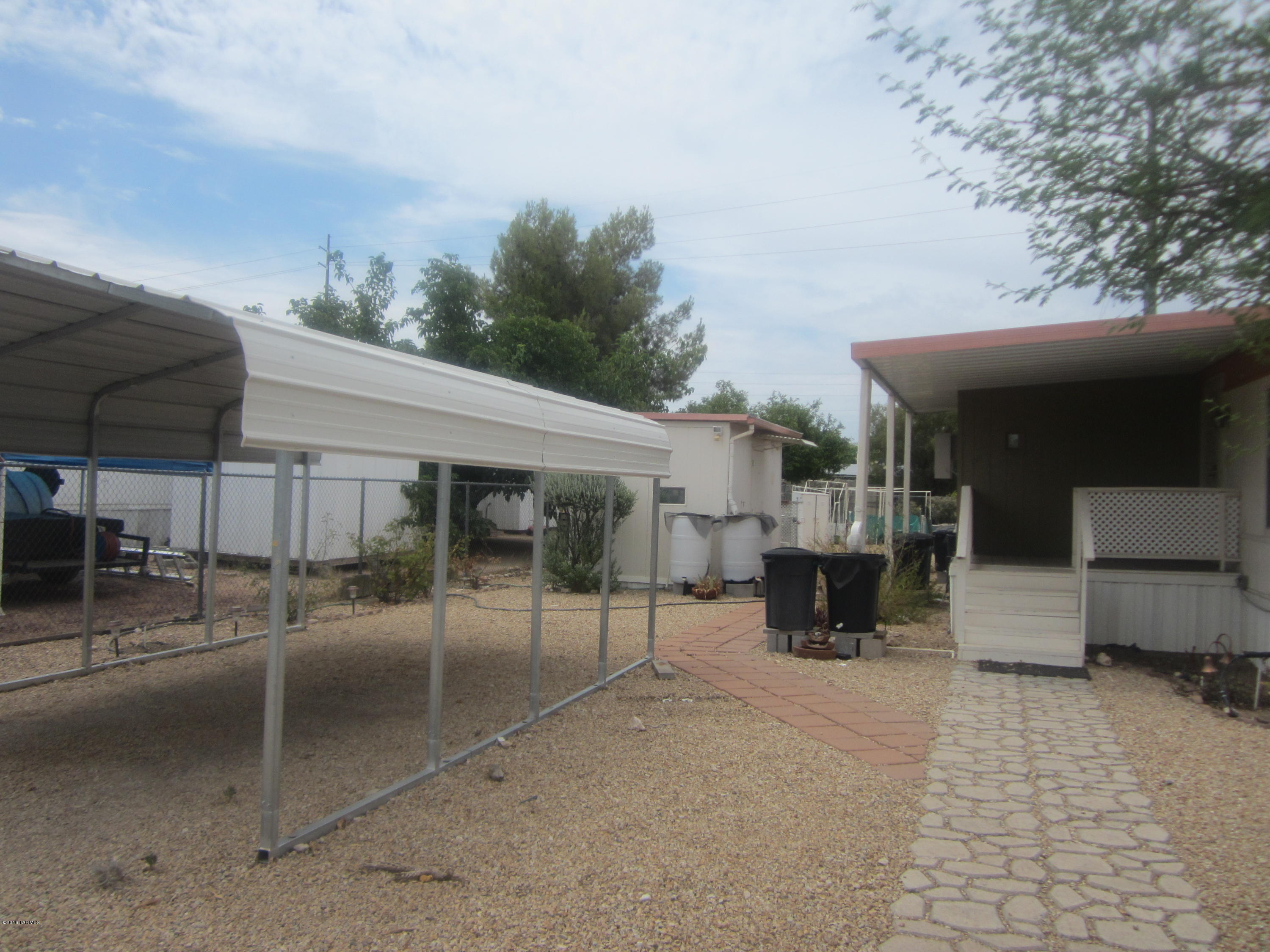 Look at all the Extras you will have in this Established Neighborhood! 2 Bedroom 1 3/4 Bath 1978 Single Wide 14X70 980 Square Foot American Manufactured Home-Manufacturer National Gypsom. Home offers 12X10 Office not counted in square footage, Reverse Osmosis Water System & Water Softner. Gas Automatic Pilot Range/Oven. Central Evaporative Cooler and Cooler Window Unit in Office & A/C Window
Unit in Living Room. 3 Storage Sheds. Outside Plumbing Completely Replaced in 2002. New Metal Roof in 2008. New Water Heater in 2008. Whole House Inside Plumbing Replaced in 2013. Separate Carport entered through Double Gate. Covered Patio. Call to see this today.