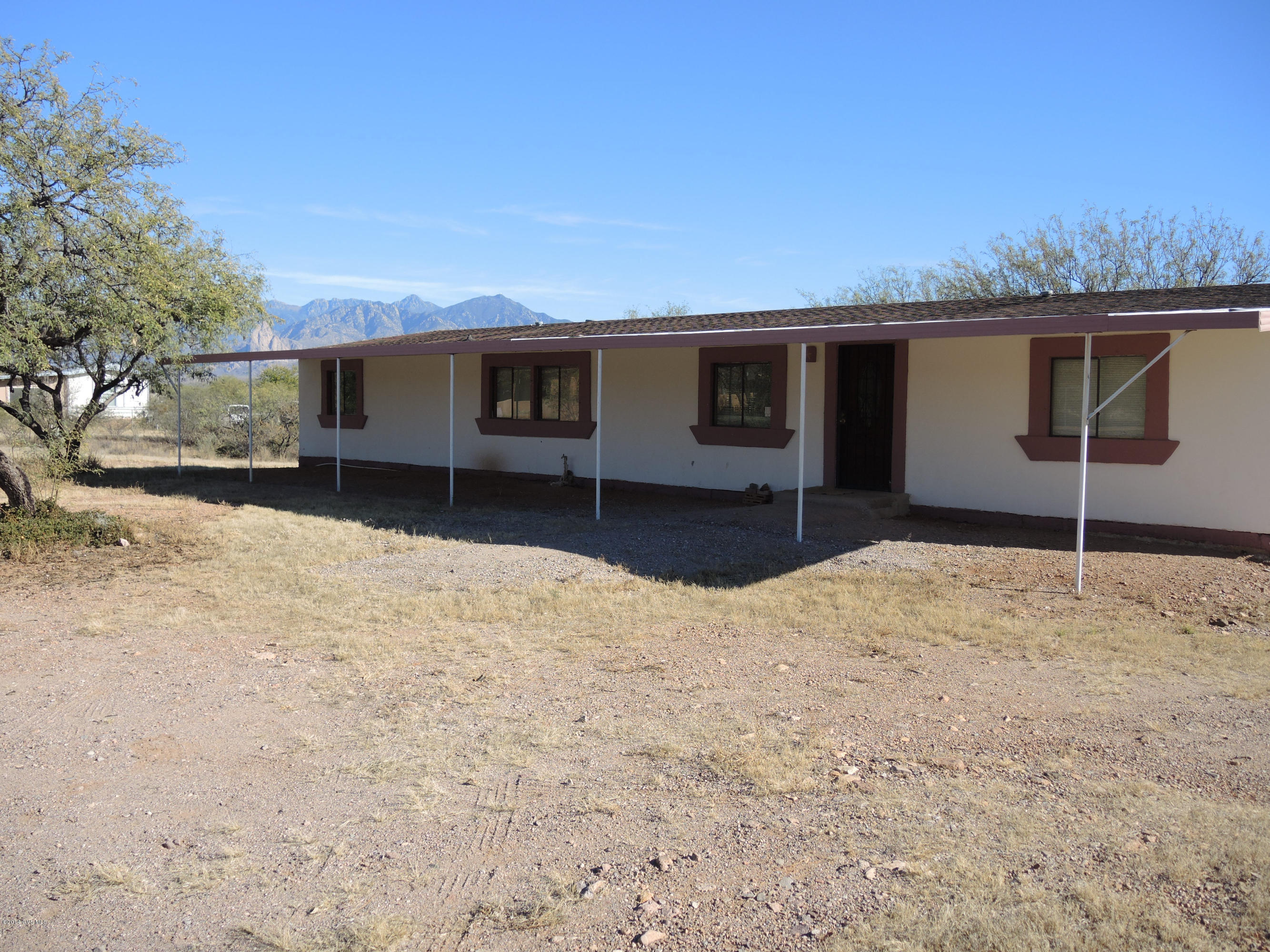 Here's an affordable reason to own your own home! This manufacturered home is on almost an acre of land and has over 1900 sqft of living space with three bedrooms and two full baths. Nice large livingroom with wood flooring, new carpet and open concept kitchen. Large yard with partial mountain views. Needs some work, but interior is in good condition. Sold ''AS IS''