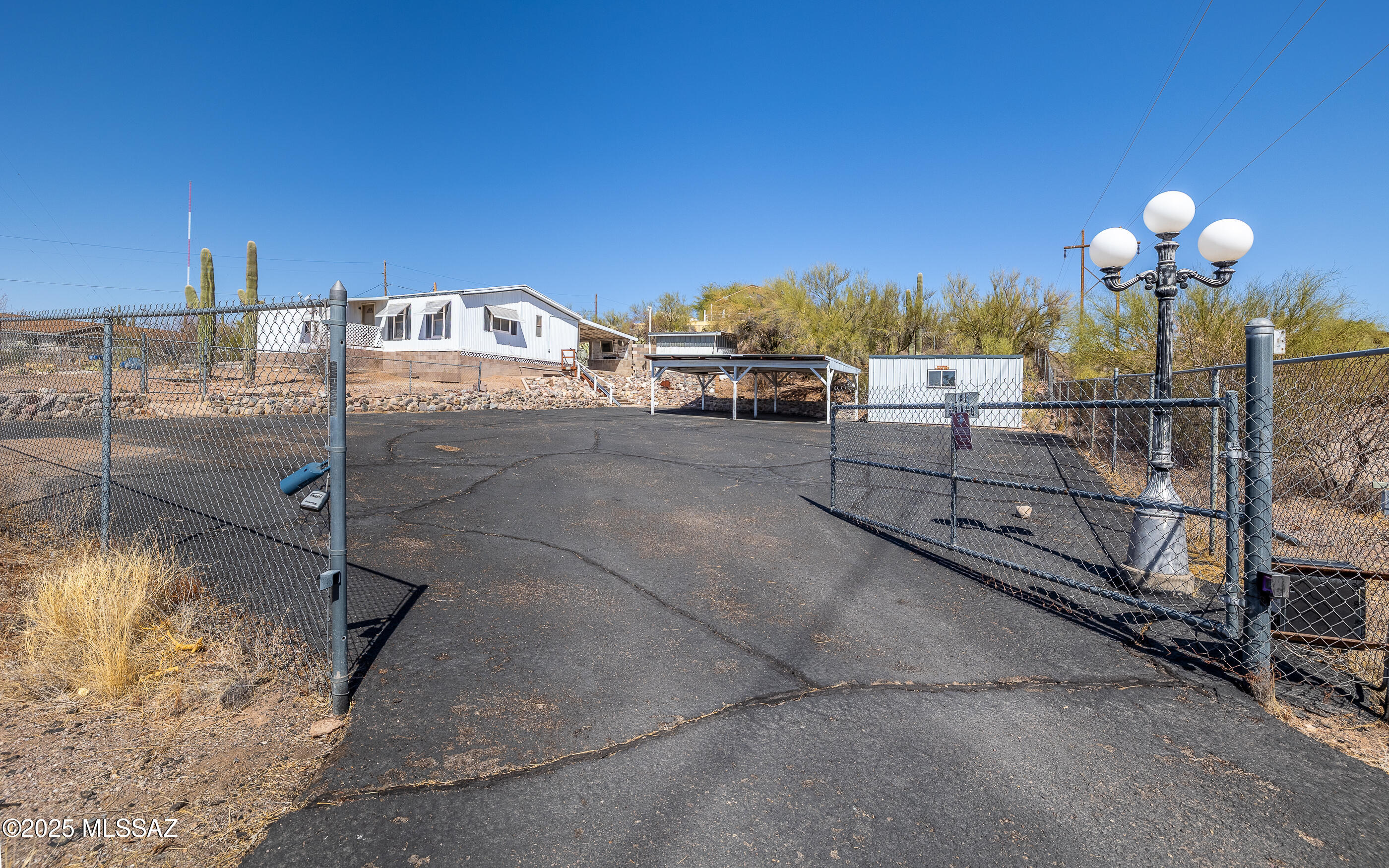 Great opportunity for Beautiful property with 1.26 acreage, large paved driveway with 2 carport, 3 sheds all with electricity at home one with AC,  open floor plan with good size bedrooms, open living living, kitchen cabinets have been refaced from original, bathroom has upgraded walk-in tub, close proximity to Starr Pass, and beautiful views