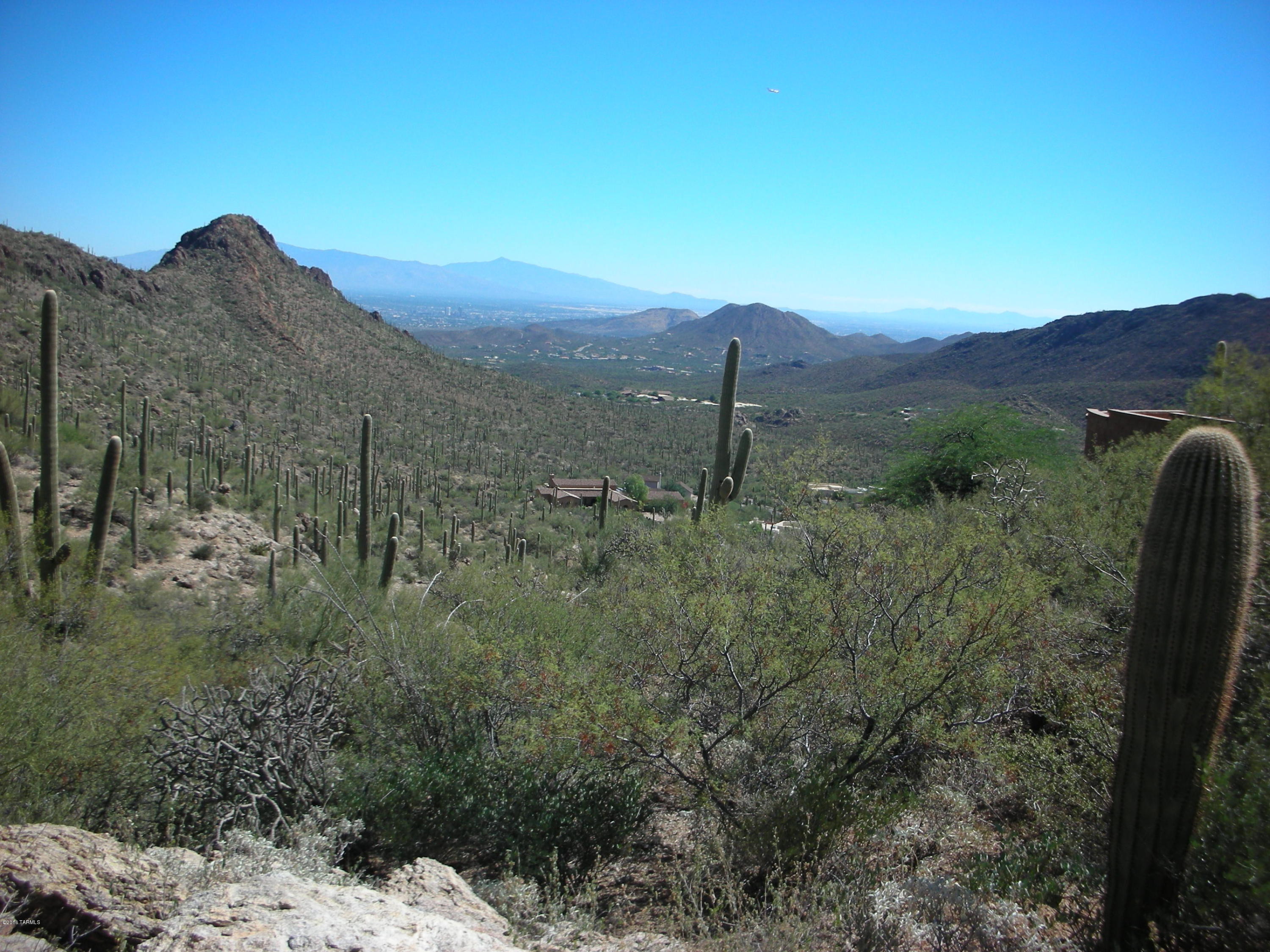 One of the HIGHEST HOME SITES in the TUCSON MOUNTAINS and some of the MOST AMAZING VIEWS ACROSS TUCSON. 5.25 Acres with OVER 100 SAGUAROS, abutting TUCSON MTN PARK in a QUIET and PRIVATE cul-de-sac location, yet MINUTES to I-10, DOWNTOWN TUCSON and U of A. GENTLY SLOPED PAD above the street with SURROUNDING HOMES built. Terrific, GATED area of HIGH-END CUSTOMS. NOW LOWERED to $169,000.