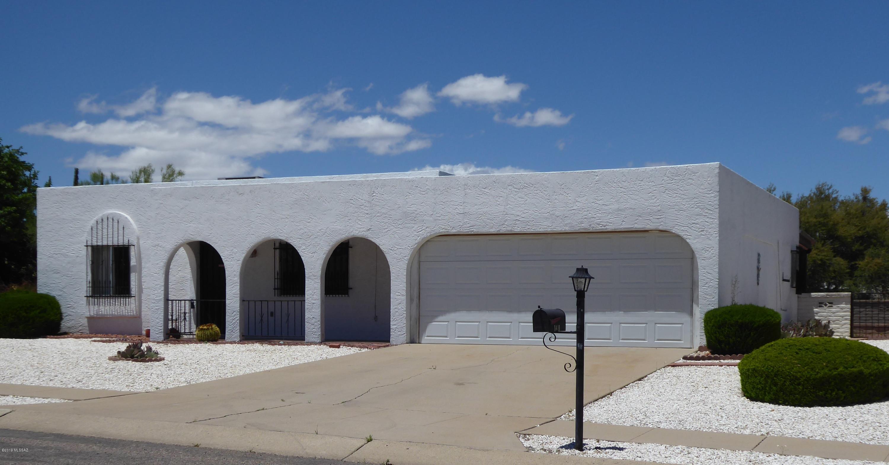 Great location! Two bedroom, two bath house with family room, two hall closets, large work shop,  storage cabinets in the  two car garage, backs to a wash. Bedrooms are spacious; one features a wall of closets the other a walk-in closet. New carpet, status of fireplace is unknown. NO GVR but it is available.