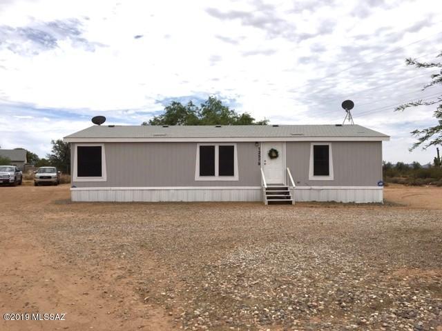 Welcome home! This adorable 3bd/2ba is move in ready and almost 1300 sq ft!  Clean, contemporary, and an open feel! Modern finishings and fresh gray paint both inside and out. Split bedroom floor plan and lots of storage space! Both hall bedrooms are good size with walk in closets. Large master bedroom! Updated wood laminate flooring, clean carpets throughout, and tile in the bathrooms! Enjoy a fenced acre that borders state land for lots of privacy.  Convenient access on a paved road and just a short drive to I-10 keeps you close to town!