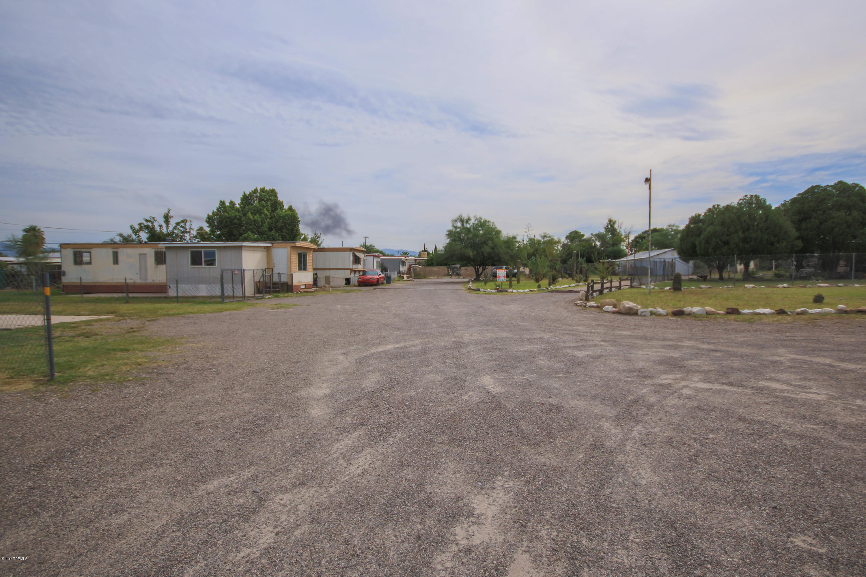 8 Mobile Home spaces plus one Single Family Residence.  1 Mobile Home & SFR are park owned, the rest are tenant owned.  5 spaces currently rented at $250/month, plus $20 for trash pickup and $14 service charge. SWG installed new gas line to house. TEP just put in new line to house. 5 Storage Sheds. Lot is fenced. House was stuccoed 2 years ago. House has separate water meter.
