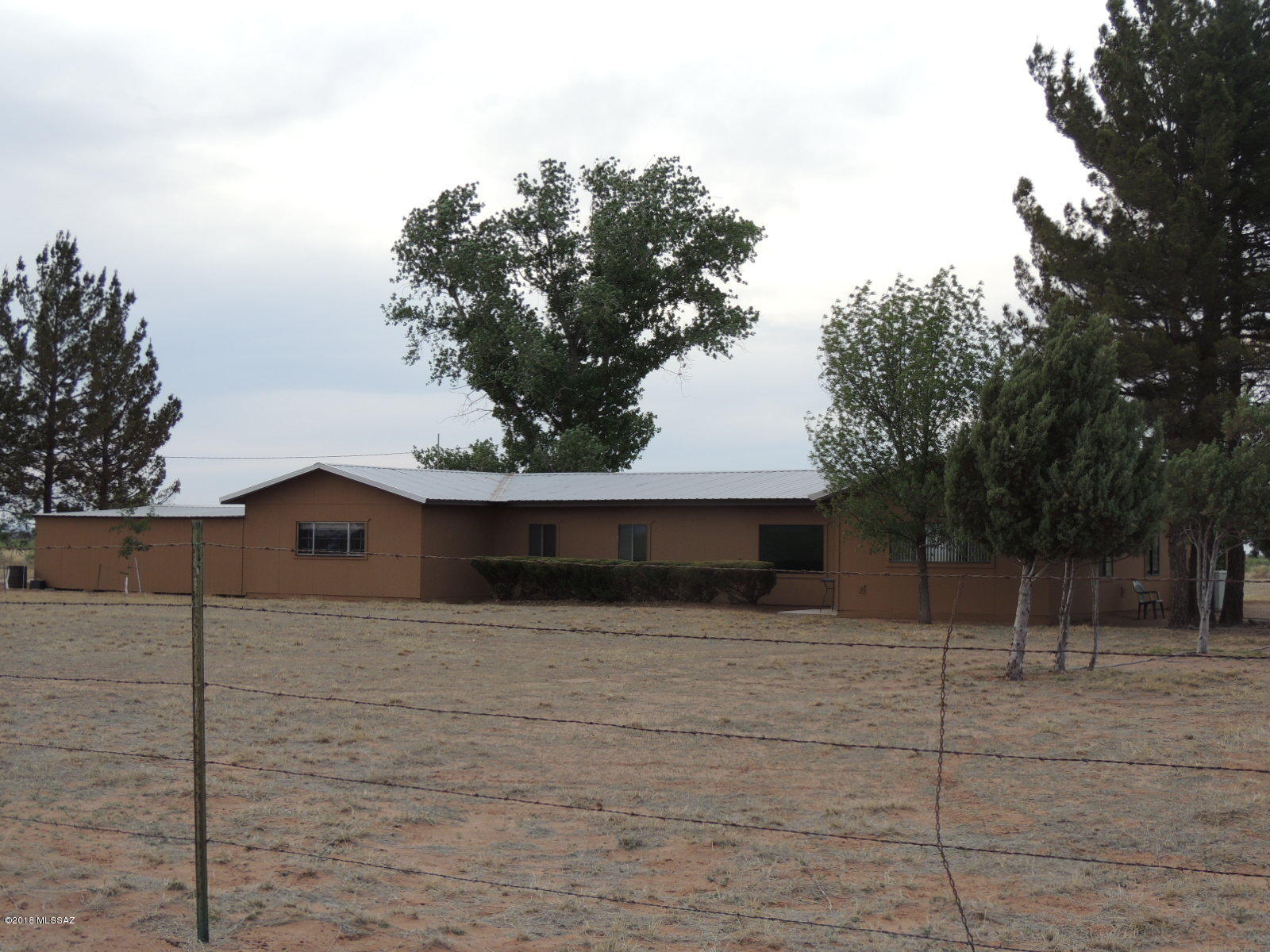 Country living with room for the kids, dogs and horses too. Endowed with country charm. Beautiful Ranch style home on 40 acres, private well, fenced and crossed fenced with horse facilities ready for your animals. Brand new metal roof just finished in 2019. Beautiful mature shade trees and 2 covered patios with views galore. Call today.