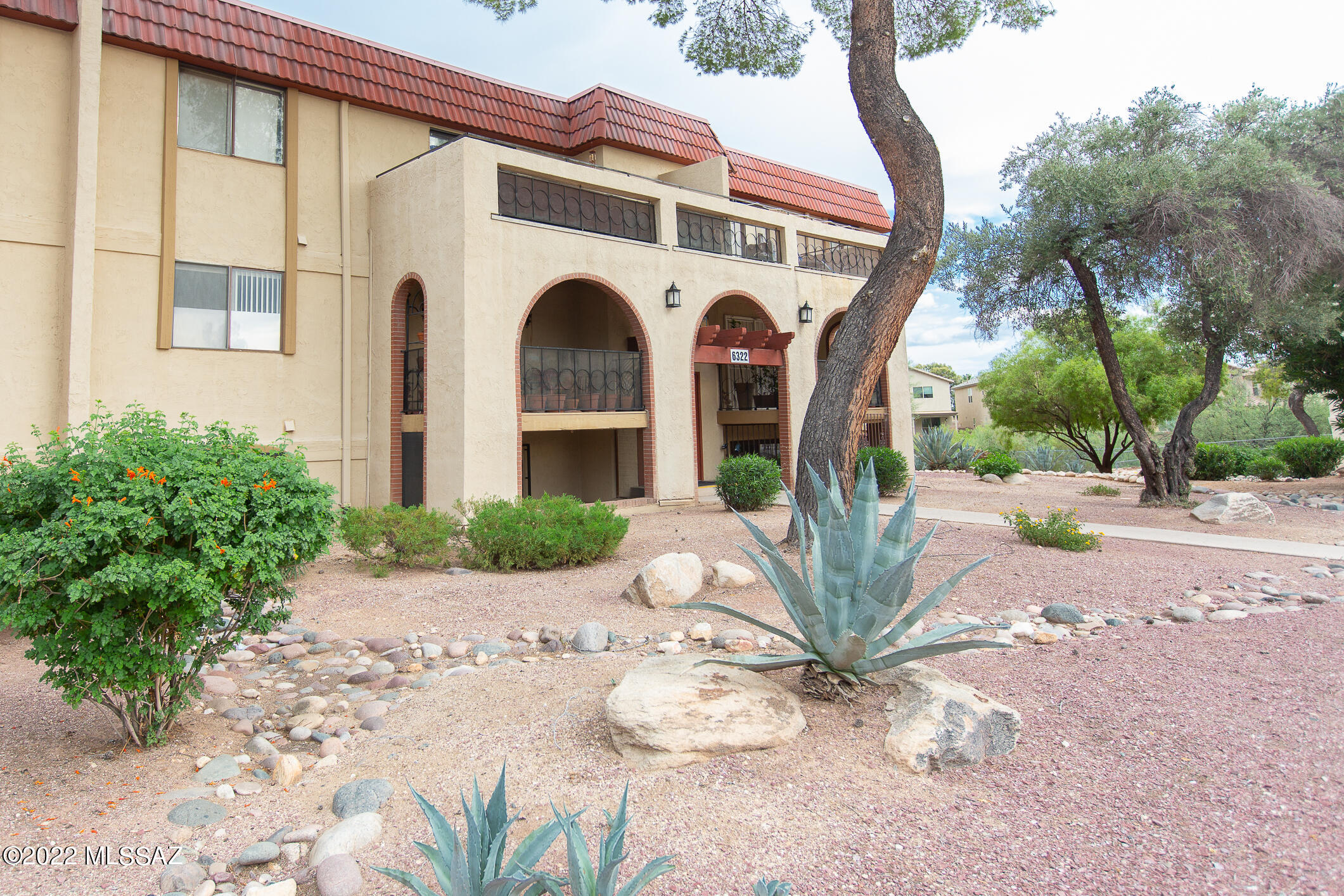 Southwest Charm in this Garden Level Unit, Tucked away near common area wash and beautiful desert plantings.  Beautiful Newly Sealed Saltillo Tile Flooring, Kitchen has neutral cabinets and countertops. New Range/Stove, Dishwasher, Faucet and the New Microwave Stays!  Lots of cabinetry and pantry Space.  Bathroom has Extra long vanity with plentiful under counter storage and drawers.  HOA covers water, trash, sewer, grounds keeping, building maintenance, roof repairs, pool, clubhouse, pest control and street maintenance.  Close to shopping, restaurants, Bus, and pharmacy.  Surrounded by beautiful desert and mountain areas, close to trail heads.
