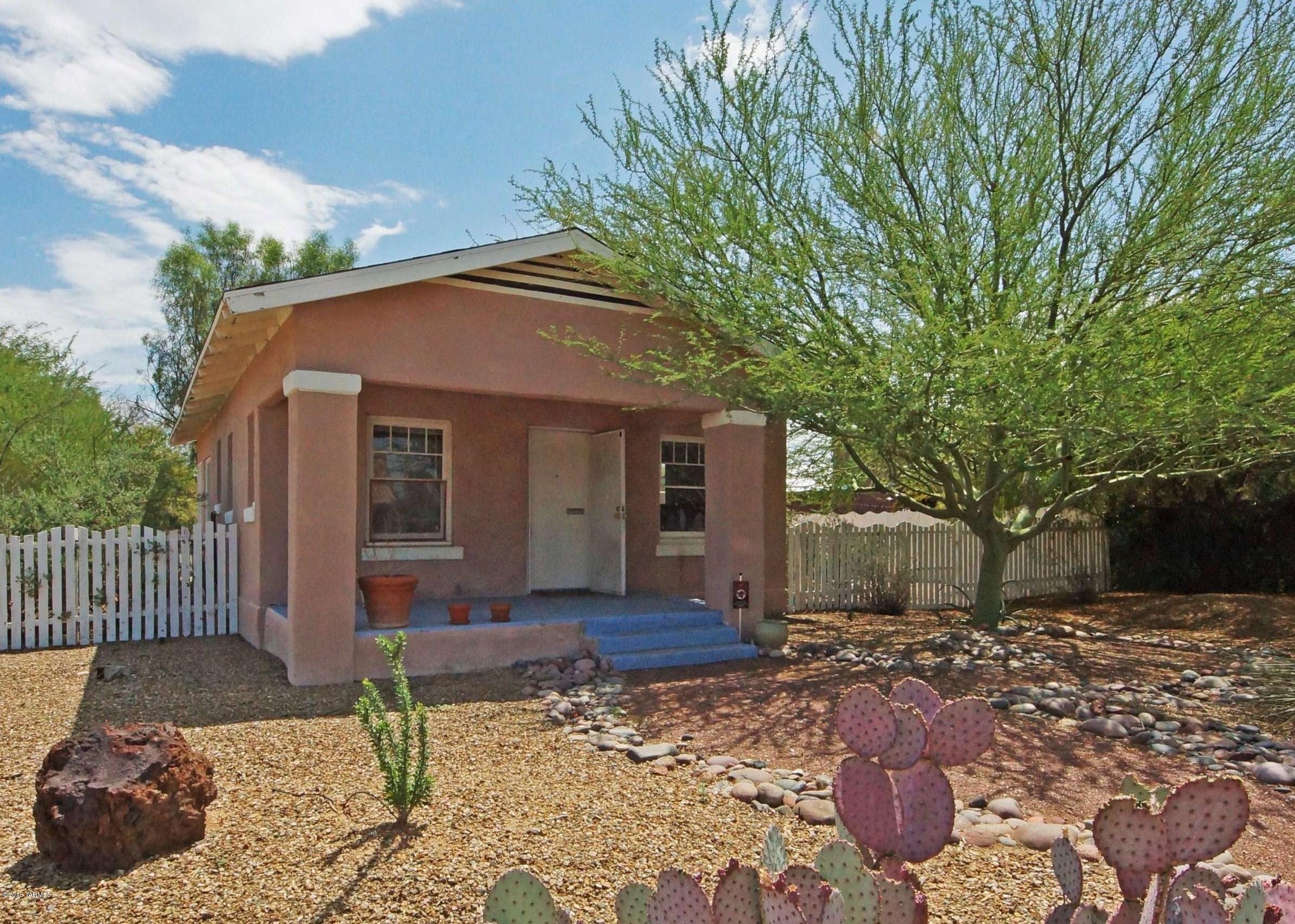 Super Cute Historic Blenman Craftsman Cottage in the Arizona-Inn area! Built in 1926, the home still retains its charm and originality.  Wood floors, wood sash windows, shady front porch and a white picket fence!  Tons of windows, light and bright, quiet area. Former artist residence.  2nd BR is the porch room, there is no closet.  Historic property allows for property tax reduction if owner occupies the home.  Prime Blenman-Elm Neighborhood, walking distance to the Arizona Inn, UA, UMC, Medical Square and the offices/shops/restaurants of Speedway!