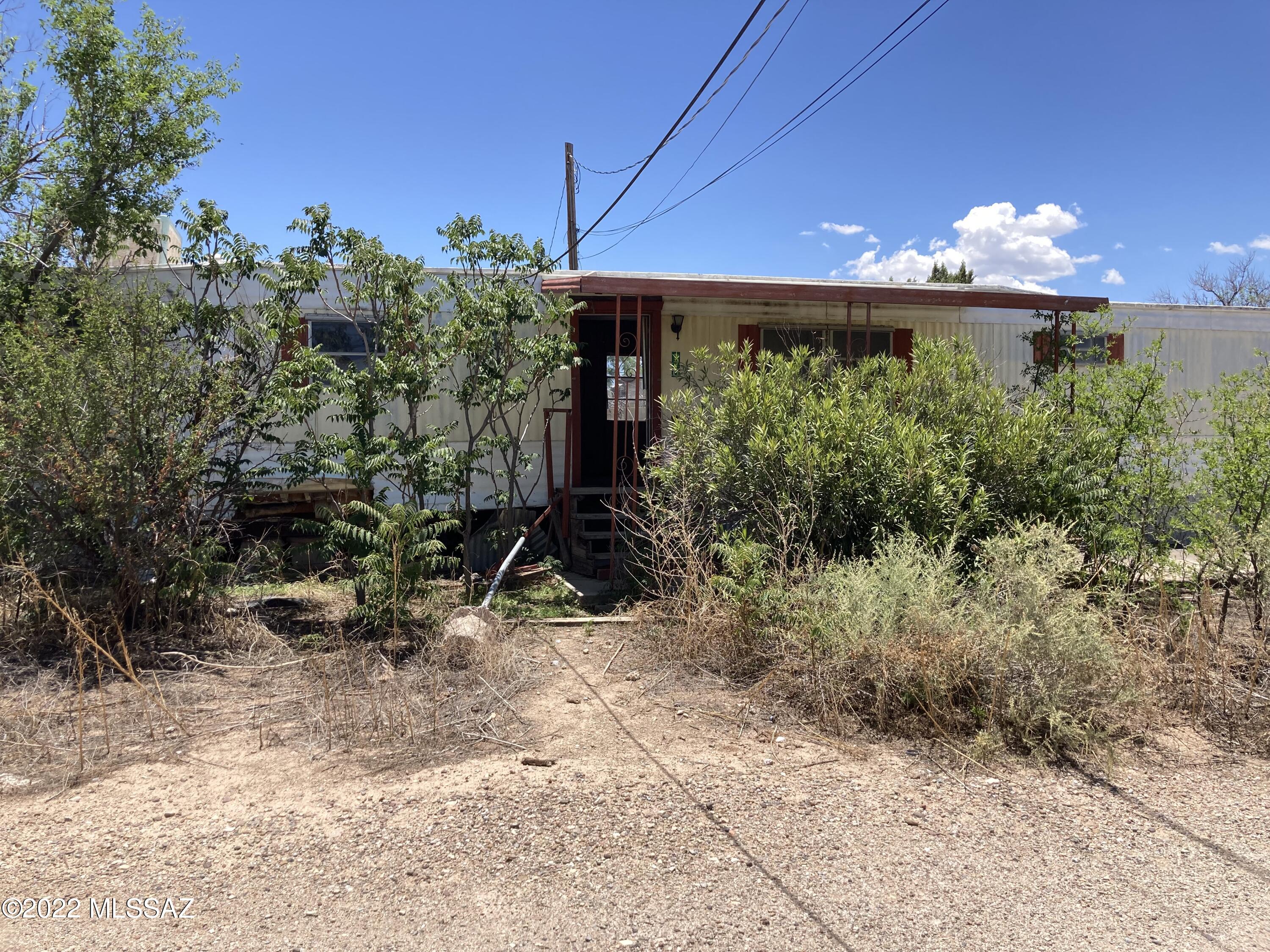 Tons of potential!  Conveniently located for easy commute to Tucson.  Well established neighborhood.  Soccer field at the end of the block, minutes to downtown Benson. Mobile is unaffixed and vandalized.