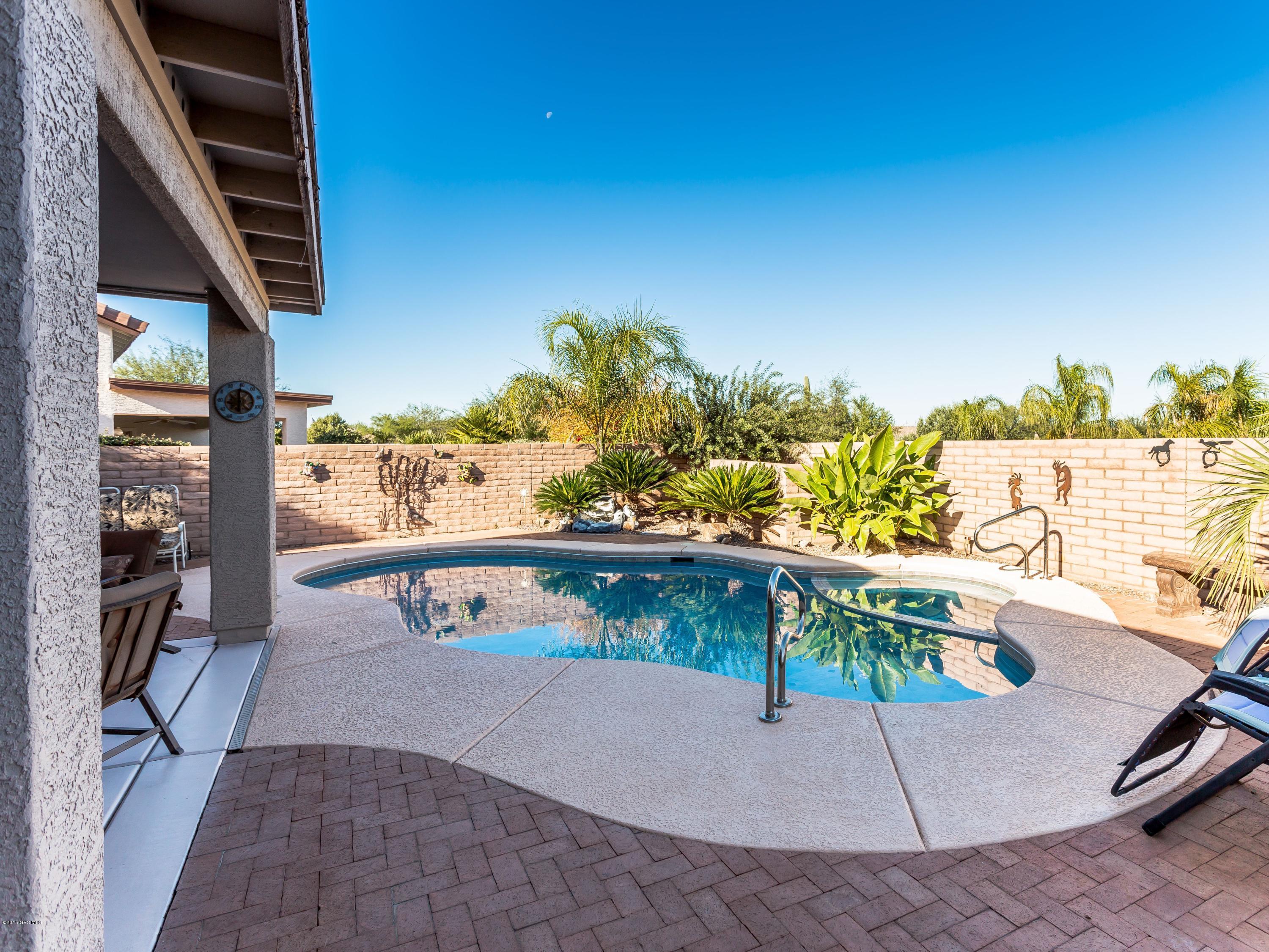Come home to your own private resort within the award winning resort community of Quail Creek. Situated on a quiet cul de sac you'll be impressed from the moment you drive up to this 3-car garage home and see first hand its outstanding curb appeal. One step through the front door and you'll be delighted with the high-end finishes throughout this lovely home. Rich paint colors adorn the walls; pops of color add drama and designer light fixtures and ceiling fans complete the overall look. The centerpiece of the vaulted ceiling great room is a gorgeous gas Kiva FP and a long wall of windows which brings in the light & backyard resort for you to enjoy. Step outside to your very own private resort complete with a sparkling pool. Come and make this special home yours TODAY.