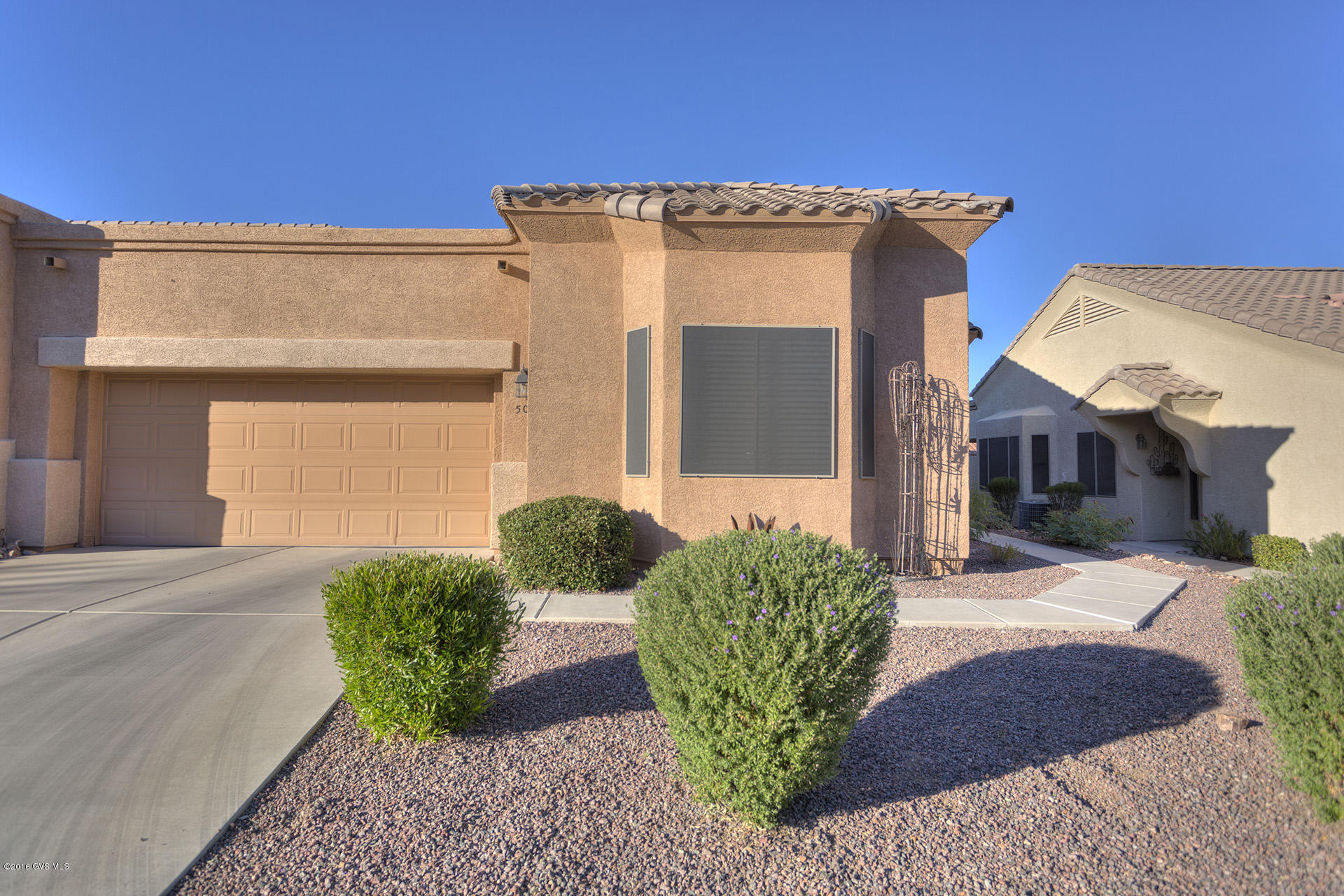Wow! This beautiful townhome has some of the best features most buyers want. This most popular TH plan features an open concept great room design w/ nice sized split bedrooms and spacious interior den/ studio.The oversized kitchen boasts abundant raised panel oak cabinetry w/ crown molding and tremendous counter space. Also a large breakfast or serving bar and a newer fridge. The great room features a cozy corner gas fireplace; gorgeous plank tile flooring; high vaulted ceilings; two tone paint and fabulous natural lighting from all the windows including bay.The light & bright dining area has a bay window and built in buffet. Master suite has a bay window, spacious walk in closet; double sink vanity and EZ care cultured marble shower. The private guest BR w/ bay and bathroom is up  front. A big slider from the great room opens to a huge covered patio and enclosed rear yard. Perfect for your morning coffee or afternoon refreshment. Also a perfect place for Fido. This home will not disappoint.|\n|The one of a kind HOA is set up much like a condo but w/ fee simple title. They maintain your landscaping, stucco, paint and roof. Also the water for your landscaping; monthly pest control; expanded basic cable TV; trash and recyclable pickup; fire, hazard and liability insurance; all common areas, gates and road upkeep; reserve fund. Come and check it out.