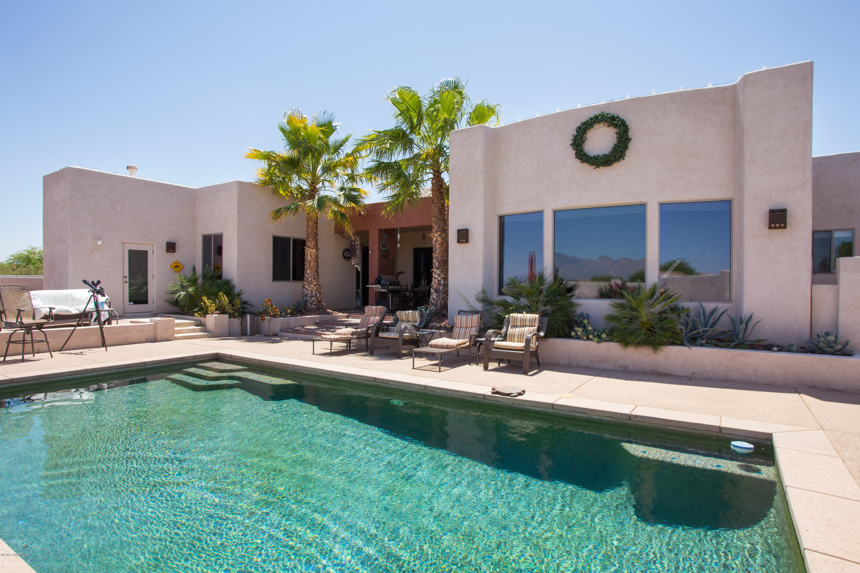 Absolutely Outstanding 4 Bedroom 4 Bath Custom Contemporary on 1 Acre Lot in Peaceful Tucson Mountain Foothills Gated Community! Open the Doors to The Super Spacious Great Room with Dramatic High Ceilings, Neutral Ceramic Tile Floors, Super Wall of Built Ins and Cozy Fireplace! You’ll Love Cooking and Entertaining in the Spectacular Gourmet Granite Island Kitchen in the Heart of the Great Room! Prepare to be in Awe of the Grand Master Suite with Massive Party Sized Shower, Raised Bubbling Spa Tub, Super Size Walk-In Closet, Inviting Corner Fireplace and Huge Windows Overlooking the Sparkling Pool with the Catalina Mountains Towering Over the City Lights in the Distance! This House is Loaded with Extras and Sure to Impress! Check It Out Today!
