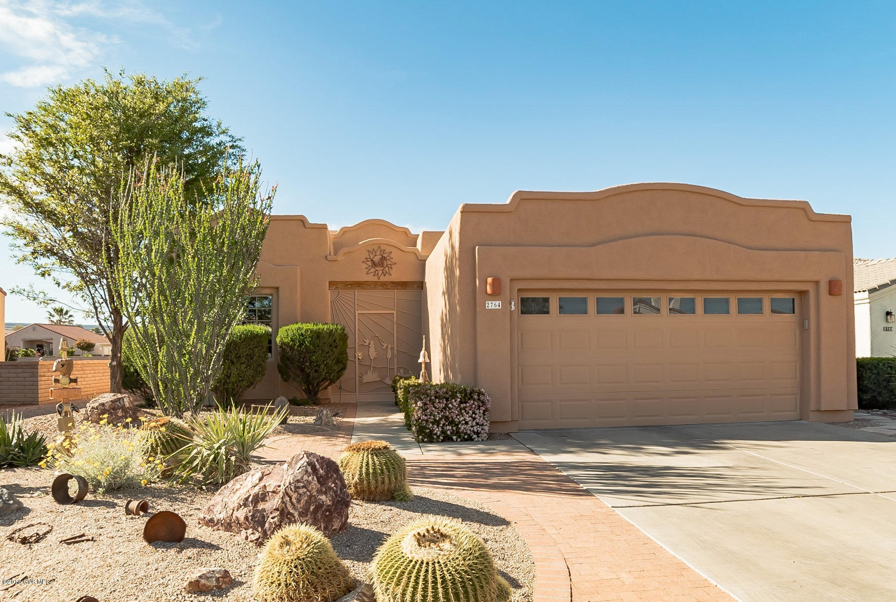 True southwest style with ornate parapet roof lines, get ready for an amazing experience from the moment you walk through the double wood doors of this exceptional home. You will love the easy care tile floors throughout the entire home! An open floor plan with interesting angles, expansive archways, peeled log posts and a corner beehive fireplace. Super functional kitchen featuring stainless appliances, solid granite countertops, an under counter stainless sink and a convenient eating nook for quick meals. An expanded master bedroom flows into the master bath with double sink vanity, an walk-in shower and large walk-in closet. You will spend endless hours in your fully screened Arizona Room which becomes an additional living room where you will relax in cool cross breezes. The  backyard oasis has a built-in barbeque bar with tile countertop that is meant for entertaining. The extended red brick patio flows out to a sitting deck surrounded by a trickling waterfall with desert palms swaying in the wind. It doesn't get any better!