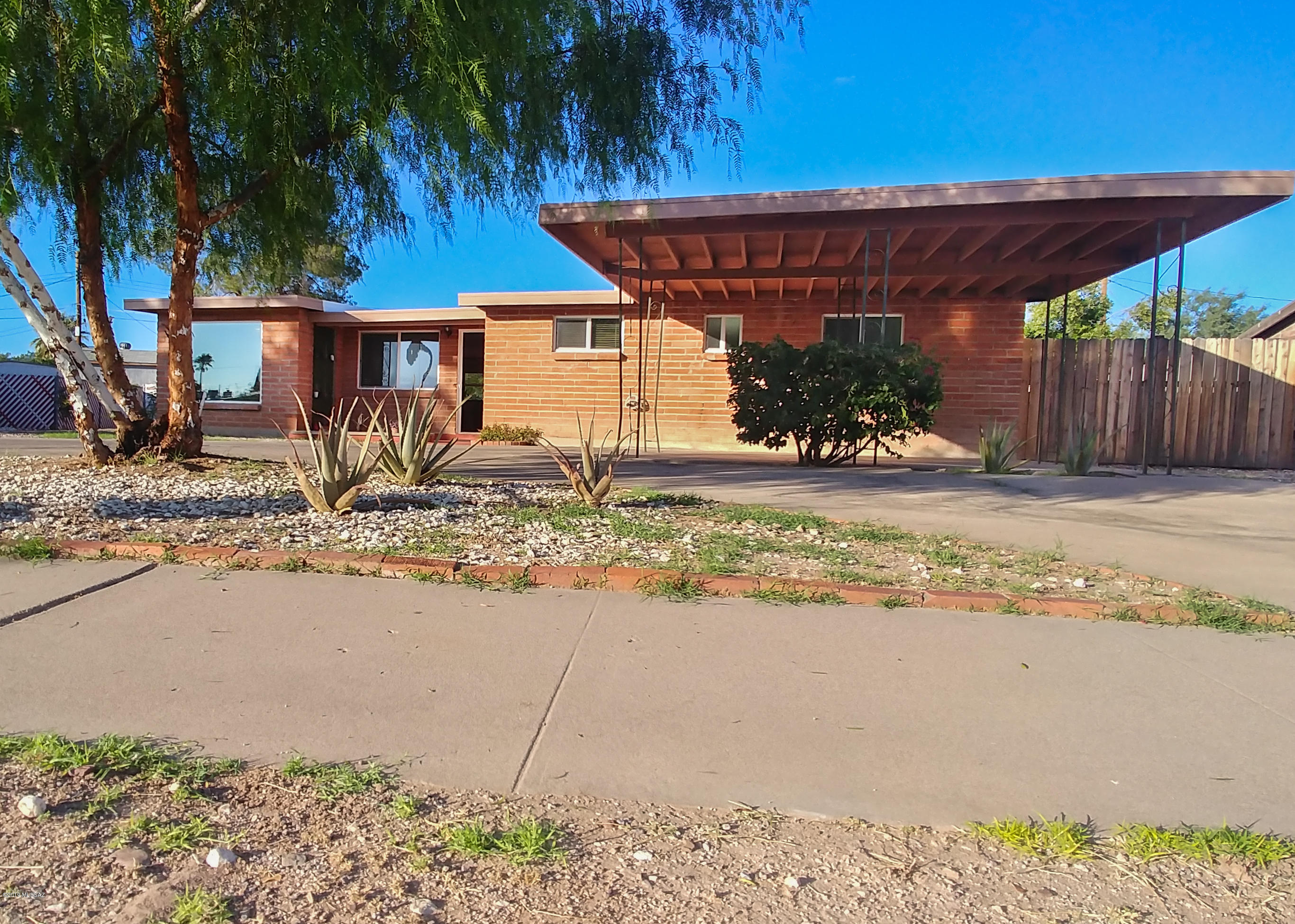 Range price $189,900-$199,900. Beautiful Mid Century home on huge lot in desirable east side neighborhood. Light and bright open floor plan. Upgraded kitchen comes with drawers for easy access to all your dishes. Sit under the fantastic porch in the back patio and enjoy the mountain views while drinking some fresh squeezed grapefruit juice from your own tree. This home has been recently painted inside, it comes with tile and wood flooring throughout, dual pane windows, roof recoated in 2019, dual-flush toilets and a large backyard big enough for a pool. Conveniently located close to the park, schools and shopping. Circular drive-way with 2 carports. A must see! No HOA! One of the sellers is licensed to sell real estate in the state of Arizona.