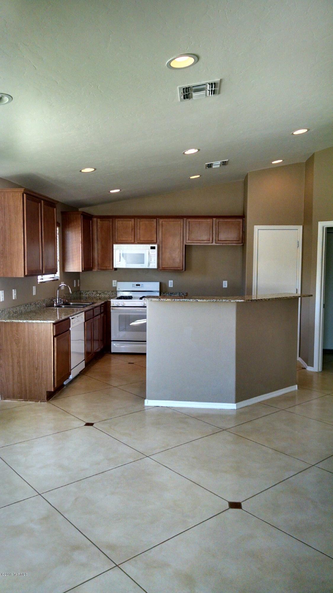 2054 sf home with 4 bedrooms/2 baths-2-car garage and POOL!  Corner lot with HUGE front, side and rear yards. Large covered patio and built in firepit and outdoor fireplace. NEW stained concrete flooring thru-out with carpet in bedrooms. Dining area/family room off kitchen. Kitchen has granite counter tops and island. Home has been professionally cleaned and is move-in ready!  Sellers are licensed real estate agents.