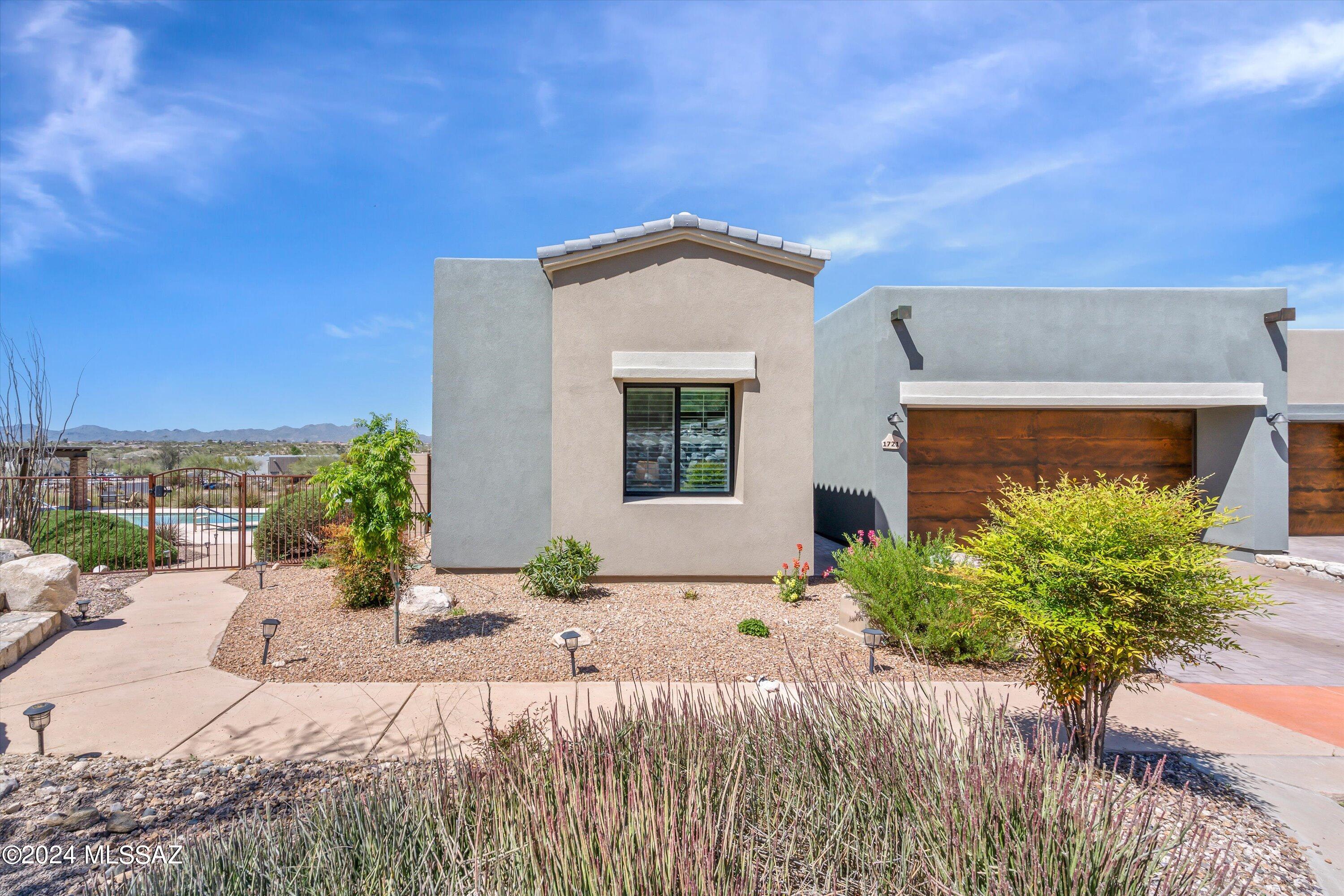 Newer Townhouse in the luxurious Gated Community of La Reserve. Meticulously designed  with custom features through out the home. Open concept living spaces, designer kitchen, stylish bathrooms, soaring ceilings with beautiful light through the home with several large windows. Luxury Plank Vynyl flloring through the entire home. Enjoy the community pool that is located just right out of the front door. This home was designed and developed by Master Builder Axios Builders just 3 years ago. Don't miss this incredible opportunity to own a newer home in Oro Valley.