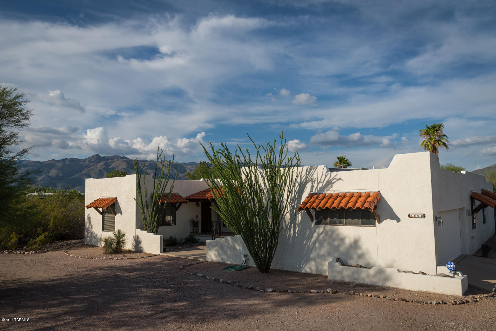 STUNNING semi- custom home with 360 degree views. This home has so much to offer with an updated master bath, kitchen, & both main baths. The fireplace will warm you on those cool winter desert nights while you gaze at the mountain views beyond the pool or city lights out front.  An Arizona room adding approximately 400 sf to the floor plan has a separate bonus room with additional access through the master bedroom. The 4th bedroom has a private exit to the back and makes for a great guest quarters.  A new roof with transferable 3 year warranty, 10 ft ceiling in family room, & termite warranty in place. Green features include 2 rain barrels, solar water heater, & dual-flush toilet. The natural desert landscaping provides opportunity for horses, goats, chickens, gardening, etc. Call now!