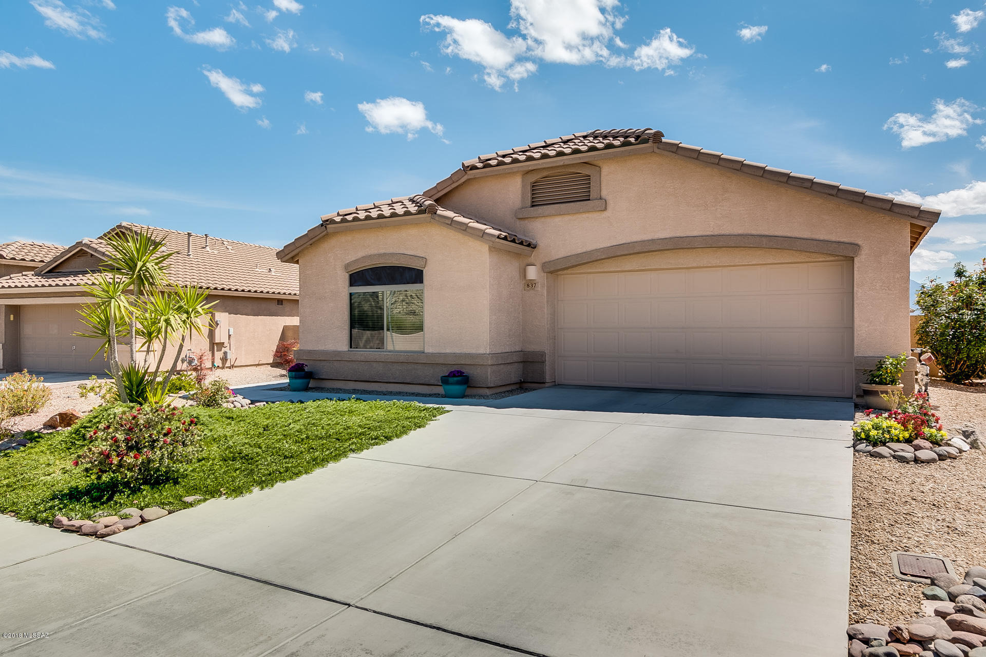 Popular Coronado floor plan in 55+ Desert Creek. This 1,704 sq.ft., 2 BR, 2 BA +Den home offers panoramic views of the Santa Ritas from the east facing back yard. Spacious open floor plan is light and bright with soft neutral color palette, ceramic tile floors in main living areas, and newer berber carpet in the bedrooms and den. Kitchen offers large island, upgraded cabinets and stainless appliances. Surround sound with in-ceiling speakers are among this home's many upgrades. Large laundry room includes a wash basin and room for storage. Out back find an extended covered patio ideal for dining alfresco, in addition to a uncovered patio for additional seating. An ideal setting for enjoying sunrise over the Santa Ritas, and a glass of wine at dusk. This one is ready for you to call home!
