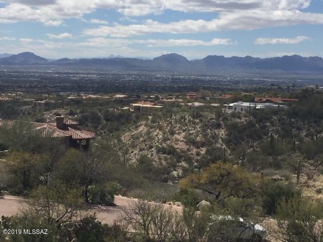Elevated hillside lot with phenomenal city & mountain views! Prestigious gated community at the end of Alvernon offers the one of the highest possible lots in the Foothills.  Minutes from shopping, entertainment, downtown and the University. Contiguous lot  just started construction. Lot lies between existing home to the west and new build to the east.