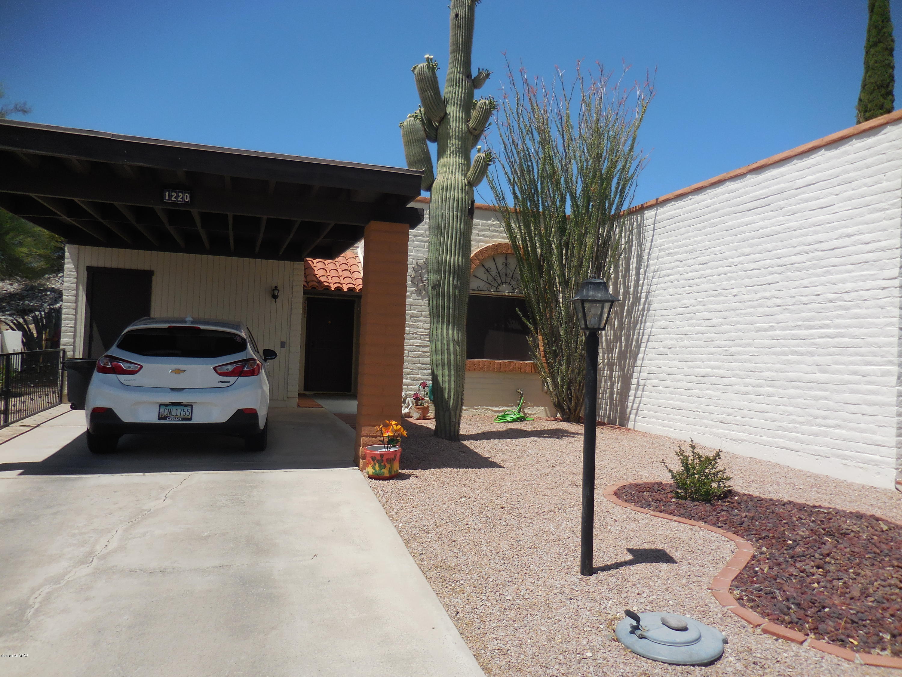 Absolutely delightful, well maintained townhome with beautiful mountain views from front.  Desirable corner lot. end unit home.  New paint outside, HVAC 2016 with maintenance contract with Oasis, roof coated 6 months ago.  Termite contract with Southwest Pest Control.  beautiful newer security door.New carpet and ceramic tile.  Completely furnished including  65 sq ft. TV and stand alone electric fireplace.   Very private patio.  2 storage rooms.  Don't miss this one!!!