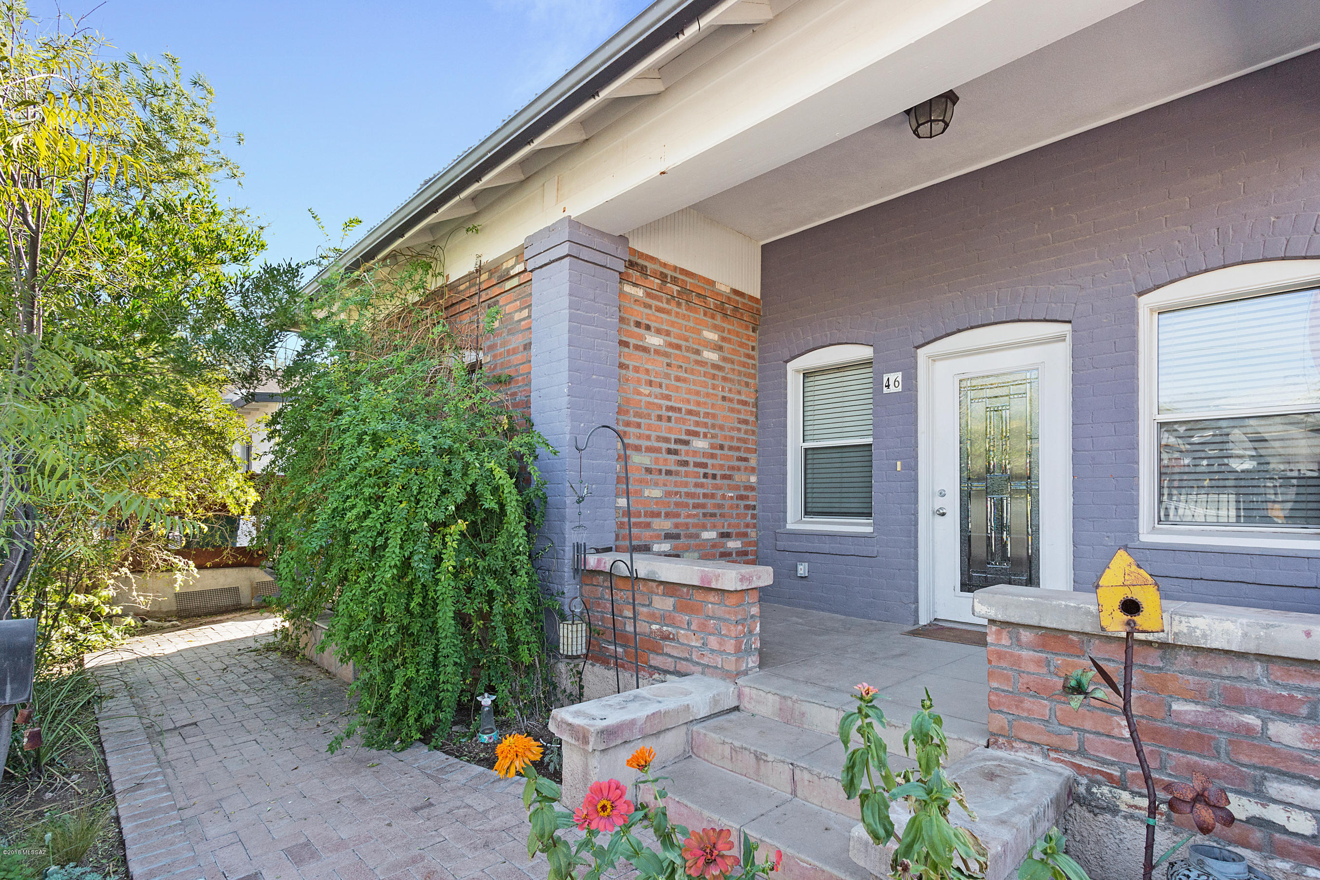Fantastic Barrio Viejo home. Relax on the front porch. Step into a beautifully updated piece of history w/ hardwood floors, vaulted ceilings, and tons of character. Master suite has private bath,  natural light & walk-in closet. Use it as a traditional master or a small home office. Open kitchen awaits your finishing touches. Beautiful satin granite counters, large single stainless basin & separate dining room. Updated hall bath with roomy shower. 2 more bedrooms with tons of closet space. Great Arizona room, perfect for morning coffee, hangout or library. Back patio has adjustable shade sails. Low care back yard fenced w/ large water harvesting cistern. 5 Points, Bon, Jazz nights at Cushing St, Fox, El Minuto, Moca, Tucson Music Hall & Congress