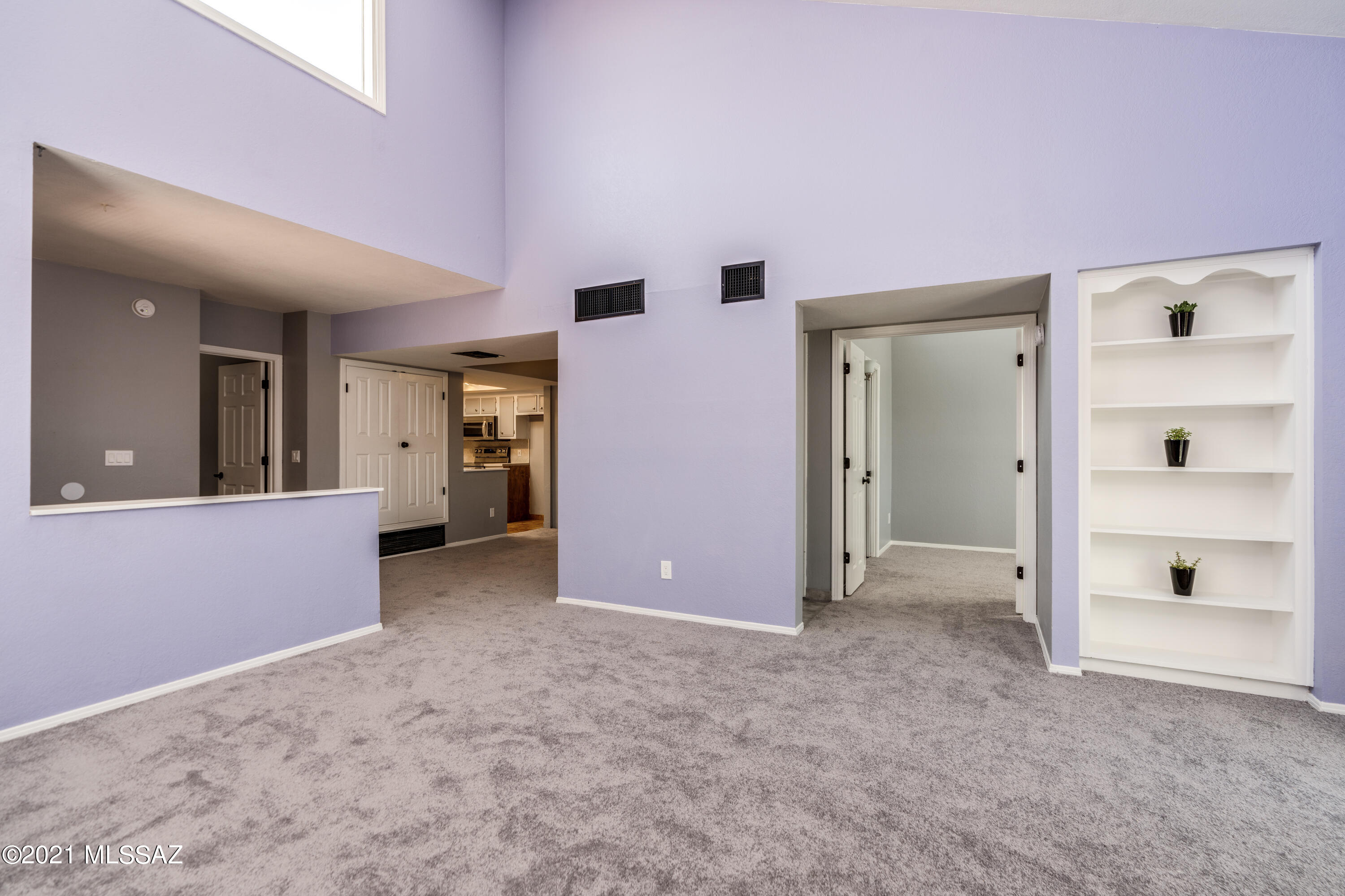 Location! Location! Location!  Upstairs spacious 2 bed/2 bath condo in the highly desirable town of Oro Valley, boasts an open floor plan, vaulted ceilings with lots of natural light and new carpet.  Brand new SS LG appliances (refrigerator, smart wifi convection elec range w/air fry, microwave) SS Whirlpool Dishwasher (2018) refinished cabinets and updated track lighting.  Large main bedroom, beautifully designed custom main bathroom with dual vanities and walk-in main closet.  Updated guest bathroom, full size stacked washer/dryer (2018).  Cozy up to a beehive fireplace to enjoy your holidays.  Community pool and spa.  Conveniently located just a few minutes from dining, shopping and more!  Won't last! Turnkey, ready to go!  1 year Home Warranty included to buyer.  Refrig delivery 11/9
