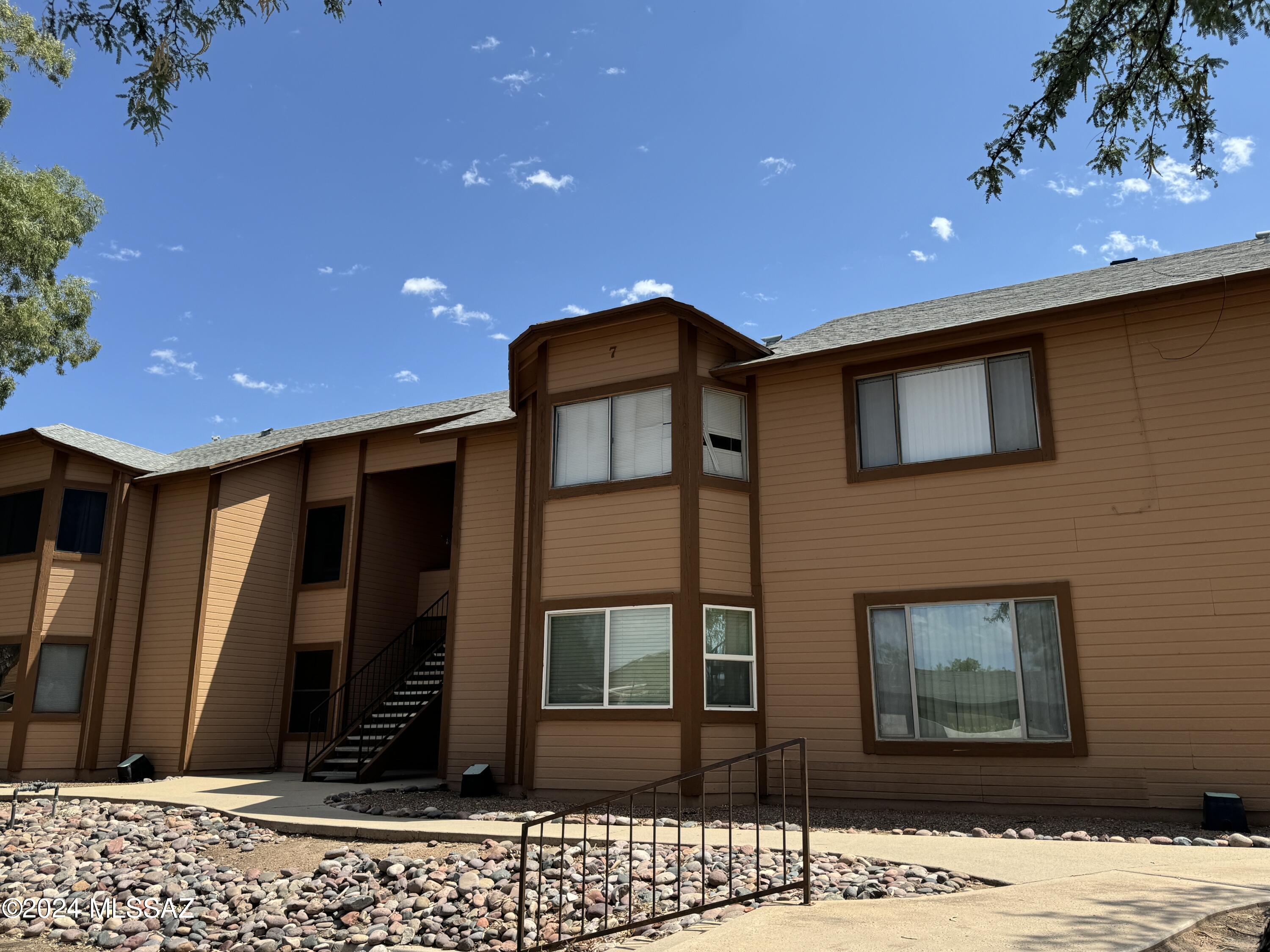 Wonderful opportunity to own a 2 bedroom 1 bath condo with a balcony, community pool, and covered parking. Perfect property to make your own. Outside you will find views of the mature landscaping in the common area on your large balcony with additional storage.  Inside you are welcomed by the great room with fireplace, balcony views, and charming breakfast area. In-unit laundry with stackable washer/dryer included. Don't miss your chance to own this outstanding opportunity.