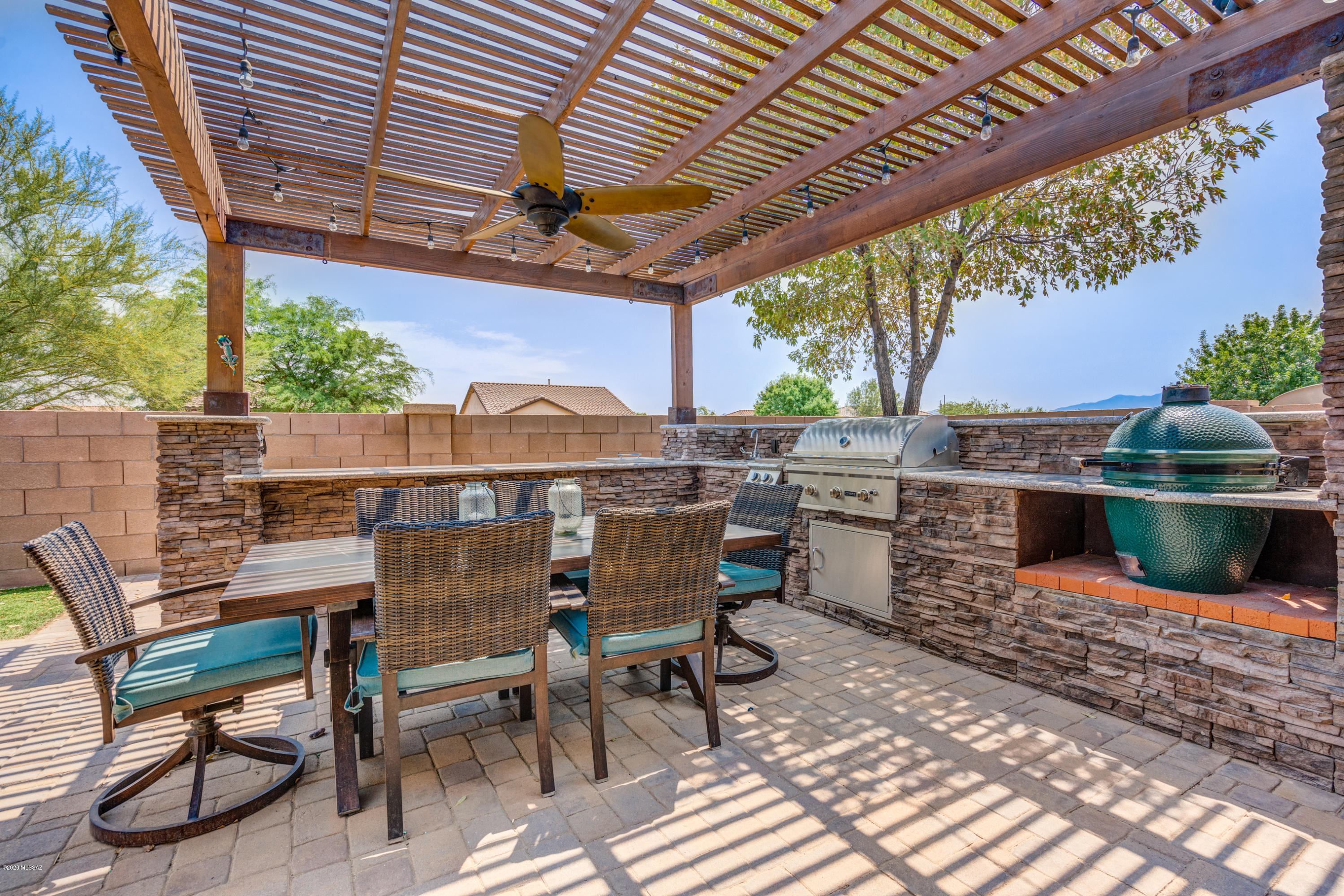 It will be a toss up what you love most about your new home... The large backyard kitchen and fireplace w/NO rear neighbors OR the stunning interior, loaded with upgrades! Enter through the covered entry and notice the beautiful stacked stone facade.  Immediately you will notice the updated tile floors that flow throughout. NO carpet here! Formal living and dining greet your guests. LUXURIOUS kitchen highlighted by a waterfall granite island with wine fridge, farmhouse sink, and upgraded cabinets with pull-outs. The Master Bedroom will WOW you! Decor wood-look wall and TWO custom walk-in closets with cedar built-ins. (you won't find these in any other home of this model). Both baths are upgraded with decorator tile & vanities. Too much to list!  All this & the amenities of Rancho Sahuarita