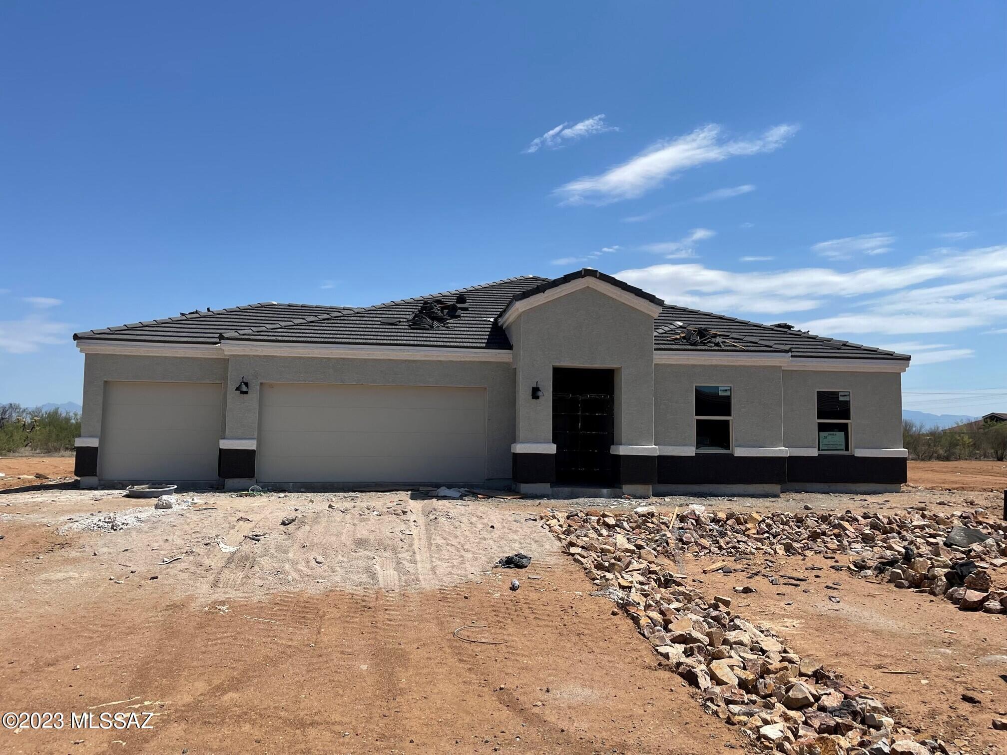 The popular Holden model. Wide open floor plan in one of our newest Tucson communities. This home includes 9' ceilings, Quartz countertops, wood look floor tile, stainless electric range, dishwasher, microwave and much more all situated on a homesite that's approximately one acre. Smart home technology package also included.