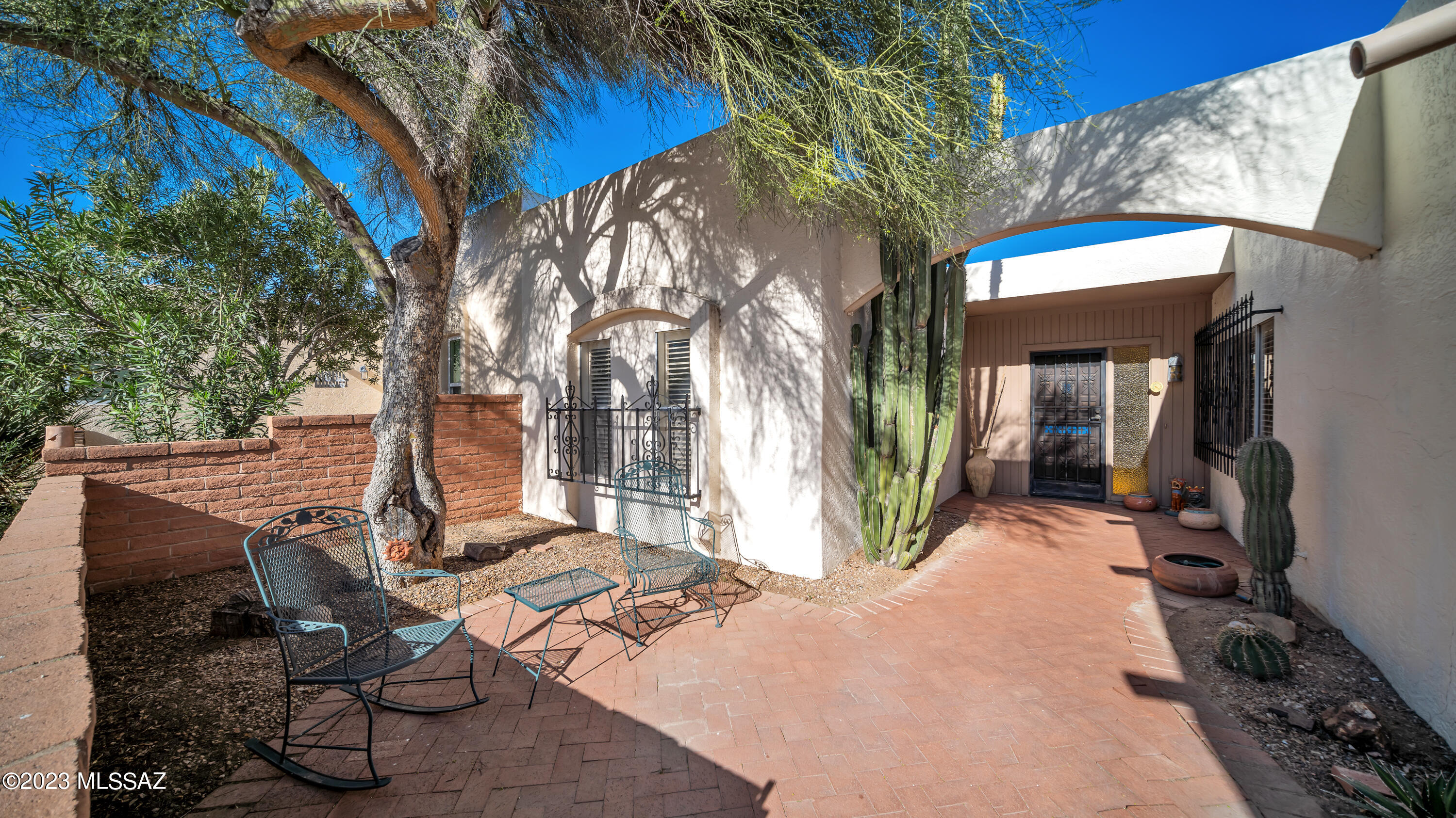 Enjoy this spacious townhome and large private back yard.  The rambling floor plan offers a large living room, with cozy Bee Hive fireplace, family room off kitchen  and spacious bedrooms.   Vaulted ceilings in living room and primary bedroom.  Inside laundry room includes washer/dryer. 
 Plantation shutters throughout add to the charm.  Relax on the large, private, quiet patio with expansive desert garden surrounded by attractive block wall.   Great view of the mountains also.  Or delight in  another relaxing area in the quiet front courtyard and desert garden.  The double attached garage provides plenty of storage.  No interior or exterior steps.   Just minutes to restaurants, shopping, churches  and freeways, this spacious and gracious home is a winner! Roof replaced August 2022.   Home Protection Plan offered for Buyer.  Heating/Air Conditioning system replaced in 2017