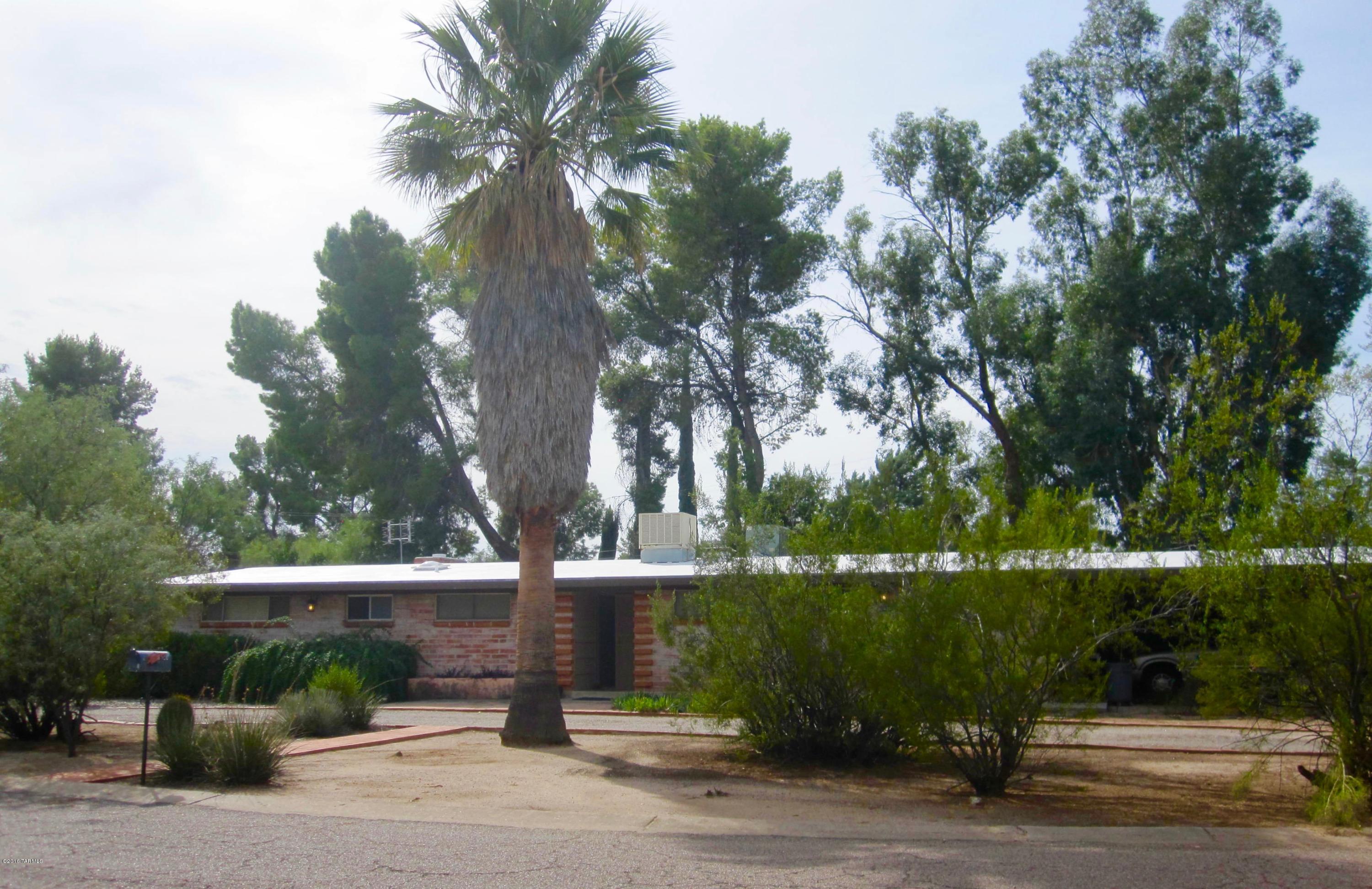 Enjoy this large, park like rear yard in desired historic neighborhood with quiet streets.  Classic ranch style burnt adobe with updated bathrooms,  updated kitchen with corian counters and breakfast bar, tile, wood floors, french doors in living room,  private patio off master with adobe wall and arch covered walkway to the backyard.  Don't forget the cozy gas fireplace.